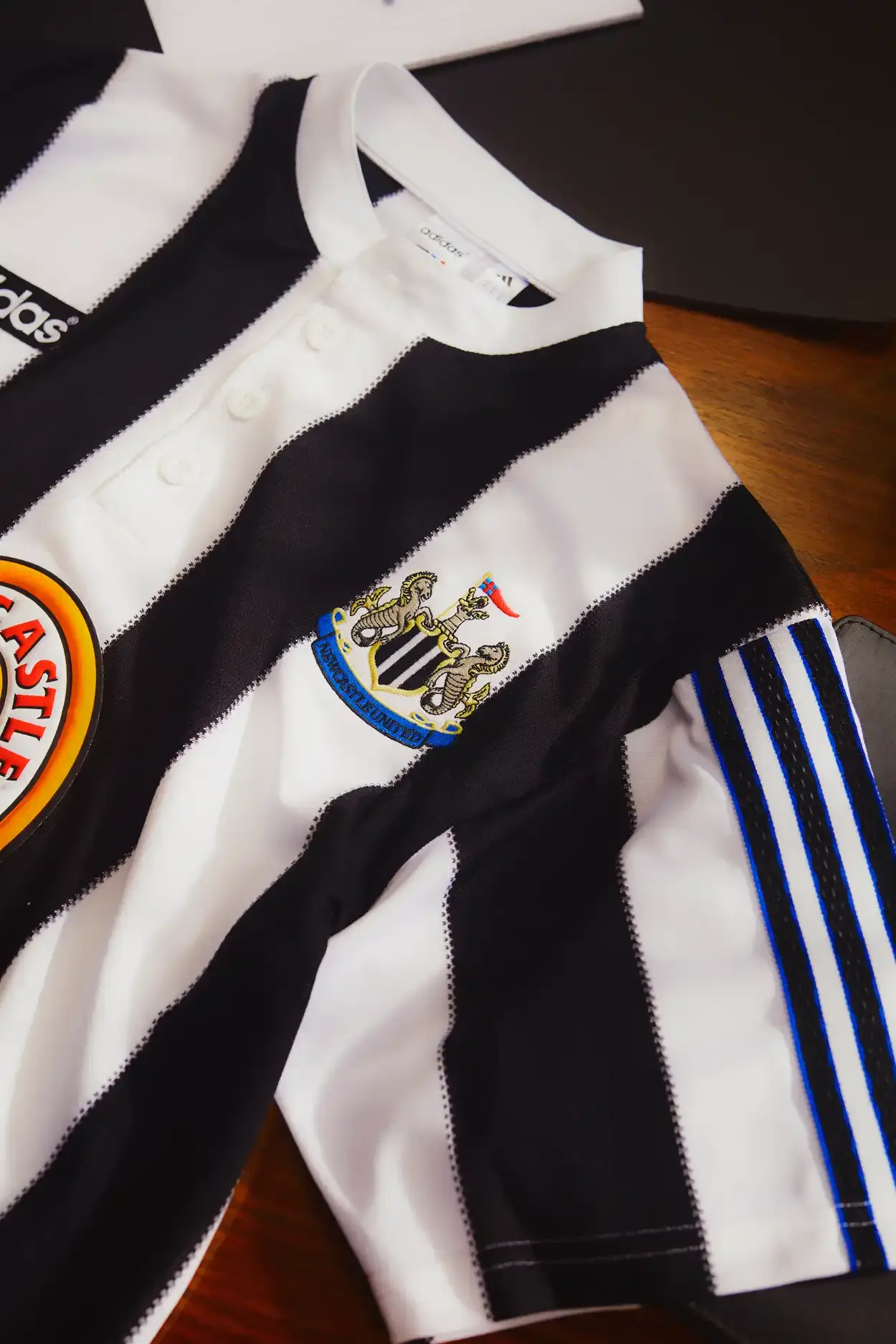 Adidas Newcastle United 1995-96 home shirt remake featuring black and white stripes, Henley collar, adidas trefoil logo, and Newcastle Brown Ale sponsor (image 3 of 5)