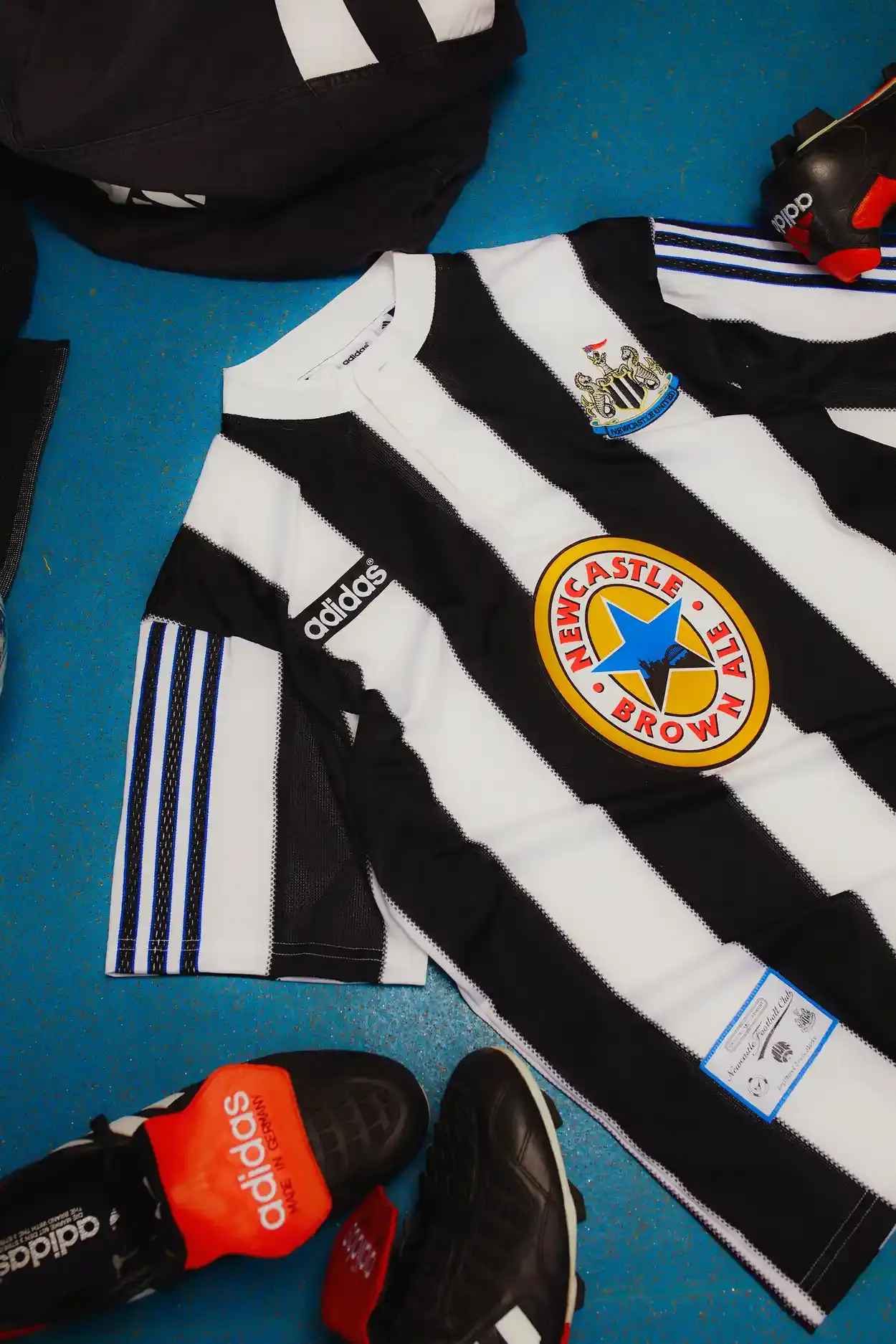 Adidas Newcastle United 1995-96 home shirt remake featuring black and white stripes, Henley collar, adidas trefoil logo, and Newcastle Brown Ale sponsor (image 2 of 5)