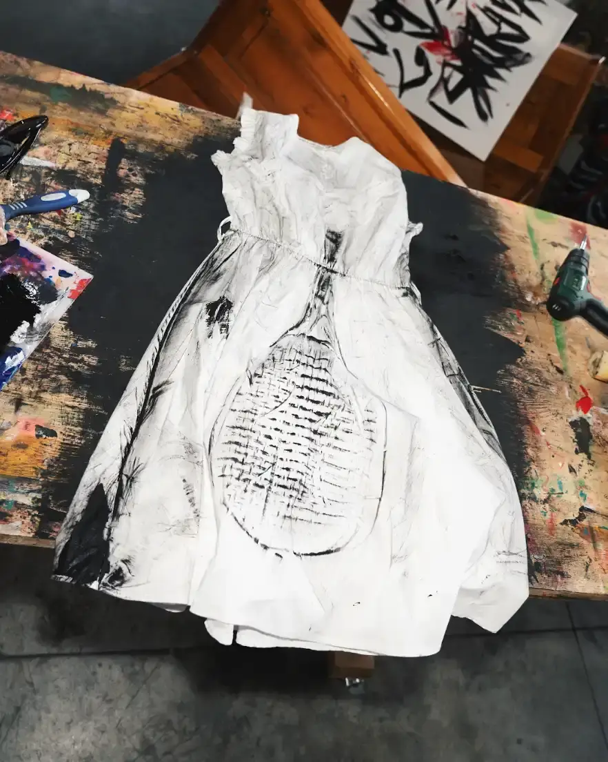 NICCOLÒ UGGIOLI: ART WOVEN FROM EMOTION photo of the Italian multidisciplinary artist Niccolò Uggioli and his upcoming solo exhibition LINES. The piece explores how Uggioli uses fabric, clothing, and performance to express deeply personal emotions, creating what he describes as "order in chaos." The article details his unconventional artistic journey from barista to artist, his collaboration with Steve Aoki, and his unique philosophy of minimalism and emotional authenticity. Uggioli's work centers on transforming everyday objects and physical experiences into meaningful artistic expressions that create visceral connections with viewers. (image 12 of 17)