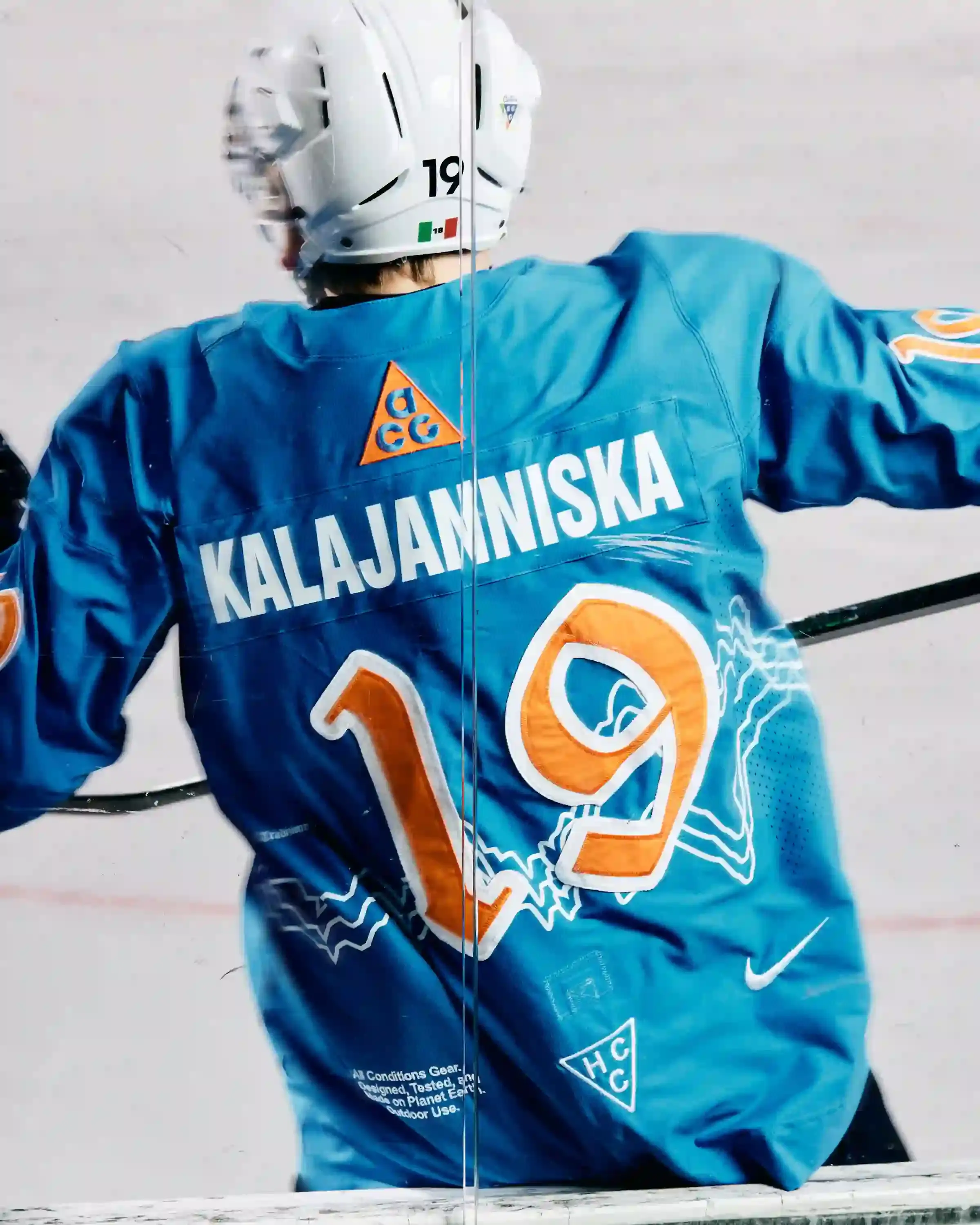 NIKE ACG AND SG CORTINA DEBUT MOUNTAIN-INSPIRED HOCKEY JERSEY image describes collaboration between Nike ACG and SG Cortina hockey team on special edition jersey. Design features Dolomite mountain silhouettes. Jersey worn once during December 7 match at Olympic Ice Stadium in Cortina d'Ampezzo. Limited quantities available at Acqua Salata store starting December 8. (image 2 of 5)