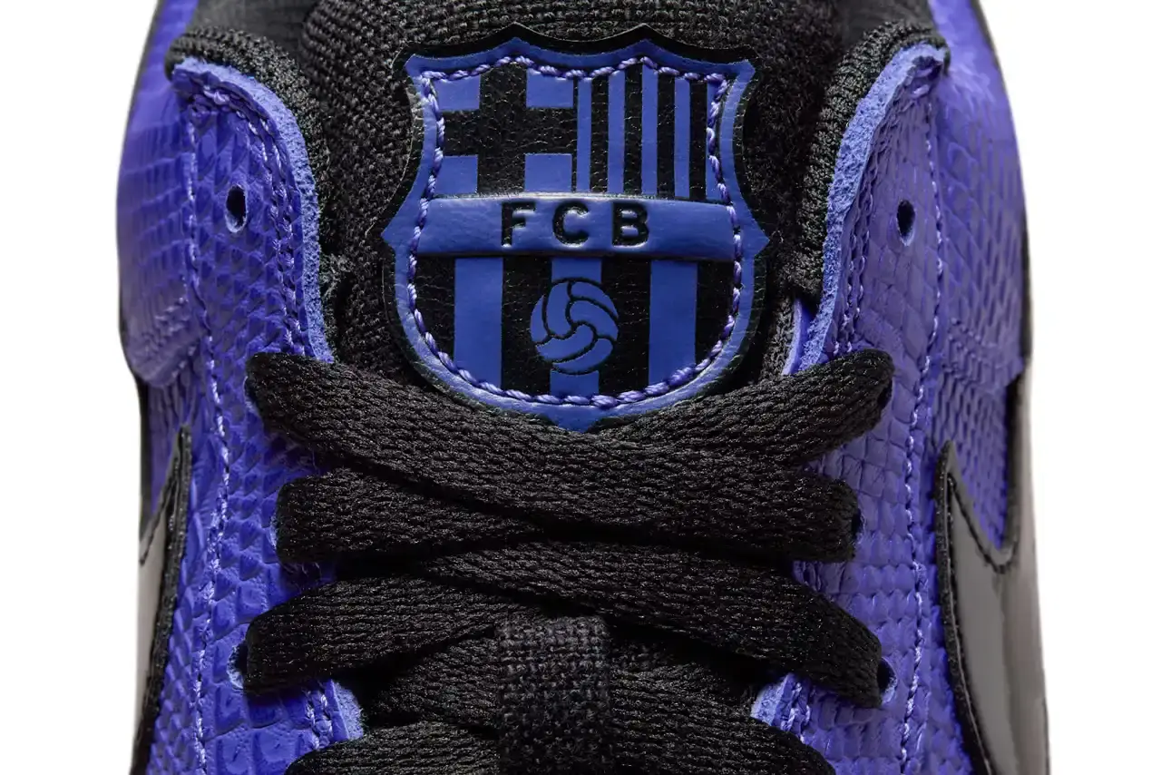 NIKE REVEALS FC BARCELONA KOBE BRYANT AIR FORCE 1 image about Nike's upcoming sneaker release featuring FC Barcelona and Kobe Bryant branding on an Air Force 1 Low silhouette. The shoe has a purple textured upper with black accents and Barcelona club crests. Includes product details, pricing at $150, and expected 2025 release through Nike's retail channels. Content is structured with bullet point summary, product specifications, and background information about the collaboration. (image 7 of 10)