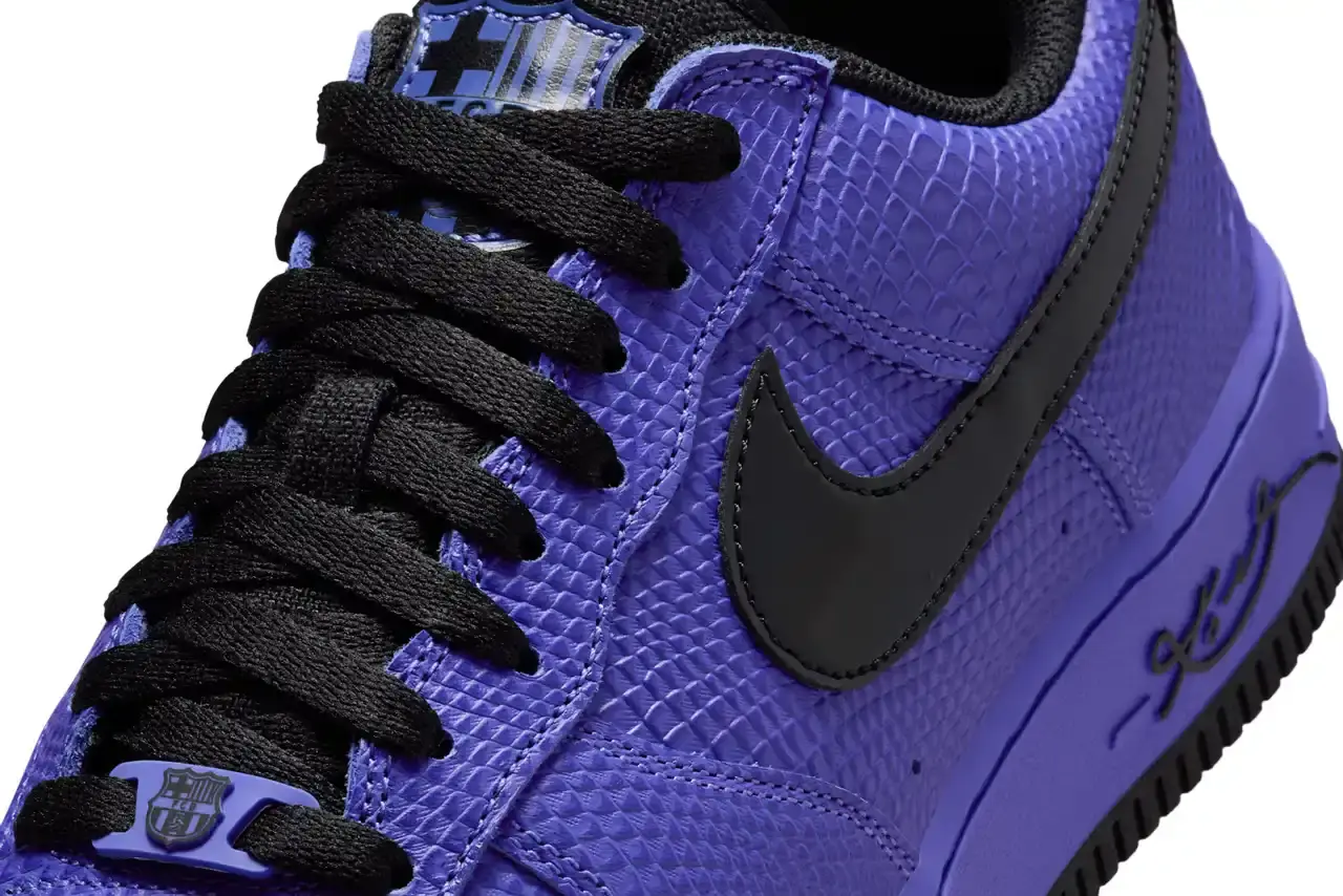 NIKE REVEALS FC BARCELONA KOBE BRYANT AIR FORCE 1 image about Nike's upcoming sneaker release featuring FC Barcelona and Kobe Bryant branding on an Air Force 1 Low silhouette. The shoe has a purple textured upper with black accents and Barcelona club crests. Includes product details, pricing at $150, and expected 2025 release through Nike's retail channels. Content is structured with bullet point summary, product specifications, and background information about the collaboration. (image 6 of 10)
