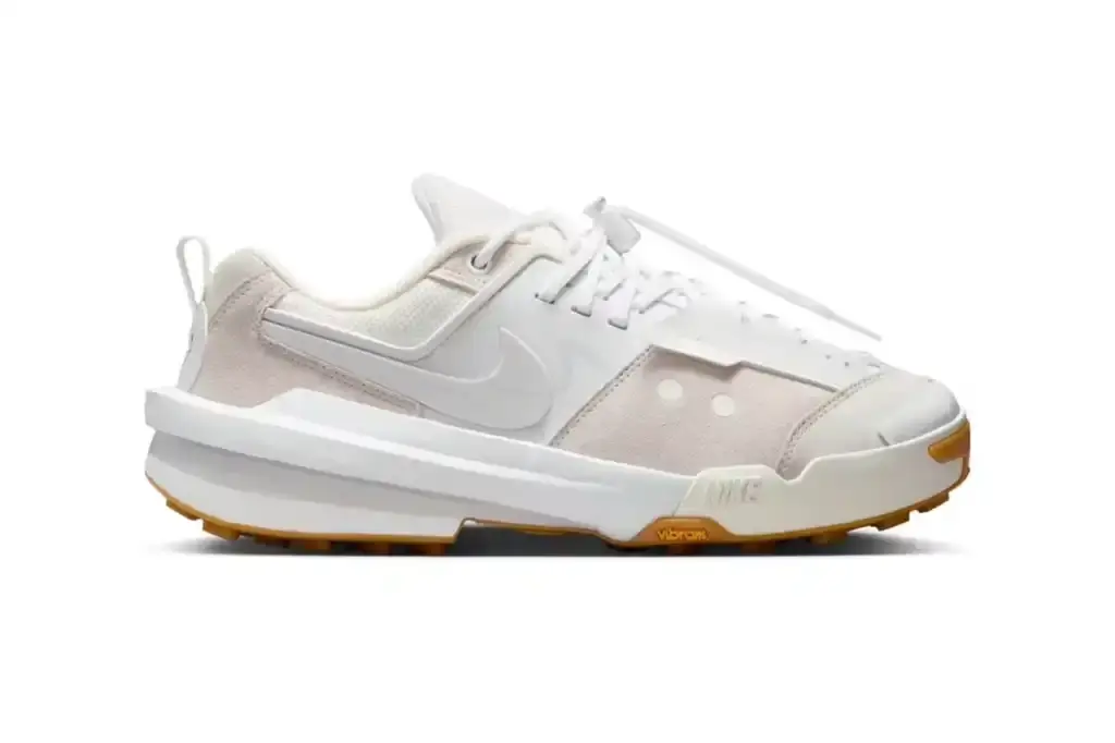 NIKE AND SACAI JOIN FORCES: THE ZEGAMADOME ARRIVES image of the upcoming release of the Nike Zegamadome sneakers, a collaboration with Japanese brand sacai. The article describes the shoe's design features, including its deconstructed aesthetic, materials (suede, leather, textile), and performance elements (Vibram outsole, ZoomX cushioning). It explains how the design incorporates elements from Nike's 1989 Lava Dome hiking boot and maintains signature sacai collaboration features like the double Swoosh logo and extended heel counter. The article details the three available colorways and confirms the May 9th release date through the SNKRS app and select retailers. (image 3 of 3)