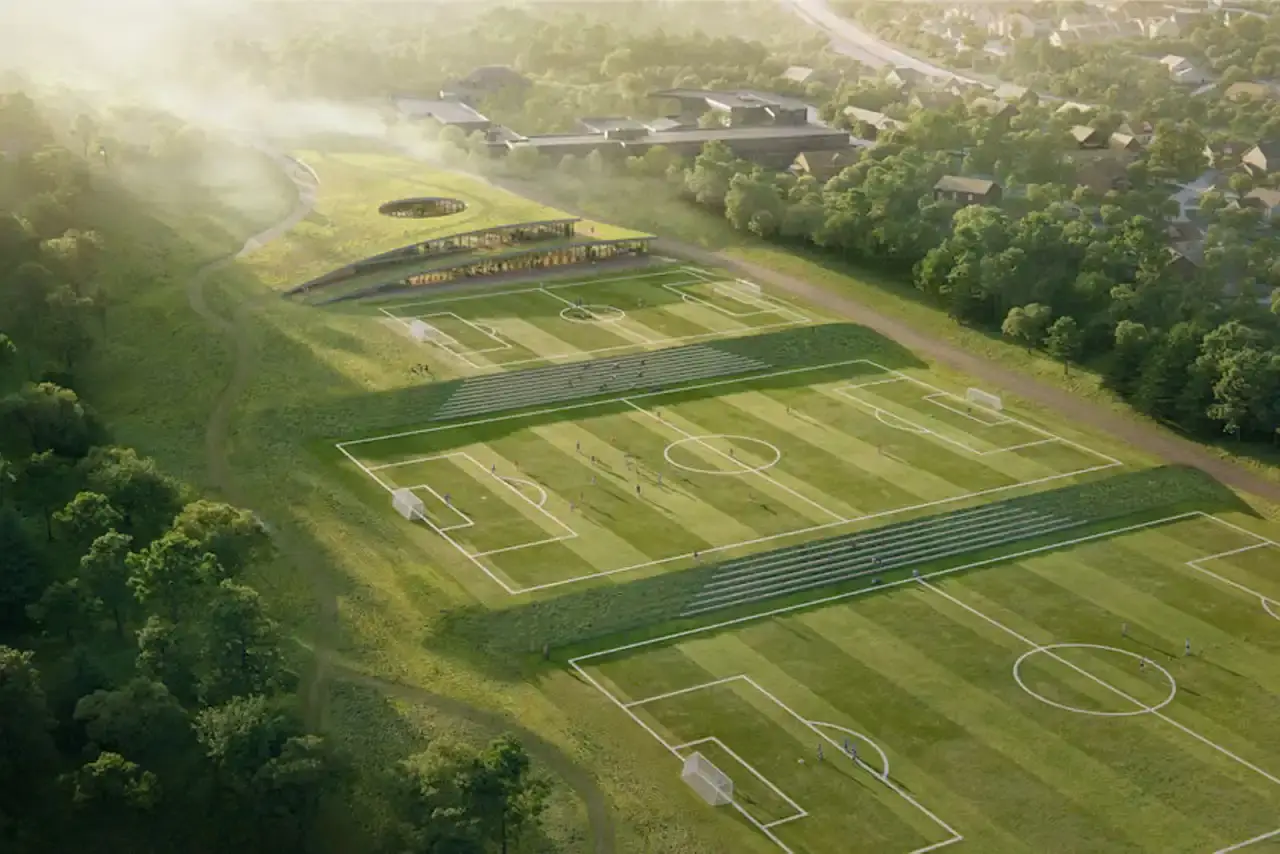 Snøhetta Bird's-eye view of the training complex seamlessly integrated into the surrounding Norwegian landscape, with terraced steps serving as spectator seating.