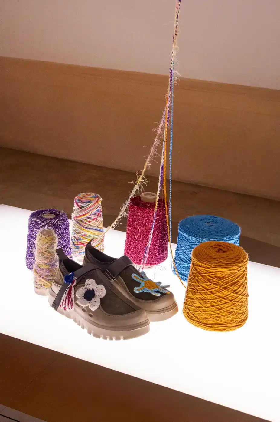 NUGNES HOSTS UGG WORKSHOP IN TRANI, PUGLIA image about a collaborative retail event between Italian luxury boutique Nugnes and footwear brand UGG, featuring a hands-on crochet workshop where participants customized UGG Peakmod boots under the guidance of artist Alicesofia at the Trani location on July 17, 2025. (image 4 of 9)