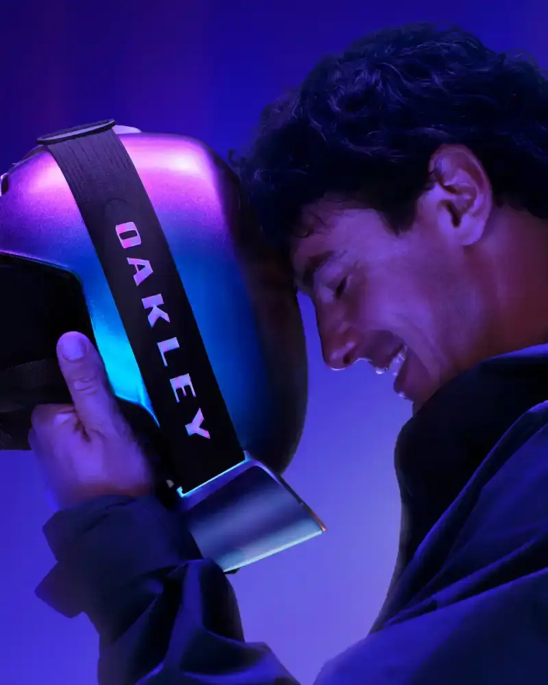 OAKLEY AURA COLLECTION USES COLOR-CHANGING PAINT Oakley introduces the Aura collection featuring eyewear, helmets, and accessories with color-changing paint in purple, green, red, and gold gradients. (image 2 of 6)