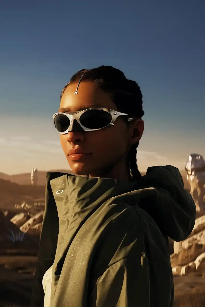 OAKLEY REVIVES PLANTARIS FRAMES WITH MODERN UPDATES Article about Oakley's rerelease of Plantaris sunglasses. The new Plantaris Ti model features titanium construction, adjustable temples, removable nose cone, and Prizm lens technology. The design shows internal frame structure through transparent elements. Release date is July 31, 2025 on Oakley's website. Article includes product details, materials, and design features for readers interested in eyewear updates. (image 4 of 7)