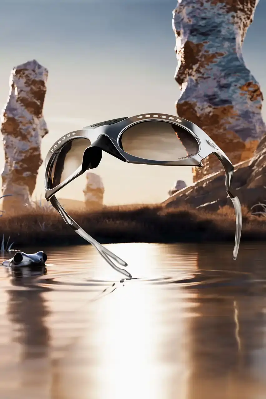 OAKLEY REVIVES PLANTARIS FRAMES WITH MODERN UPDATES Article about Oakley's rerelease of Plantaris sunglasses. The new Plantaris Ti model features titanium construction, adjustable temples, removable nose cone, and Prizm lens technology. The design shows internal frame structure through transparent elements. Release date is July 31, 2025 on Oakley's website. Article includes product details, materials, and design features for readers interested in eyewear updates. (image 6 of 7)