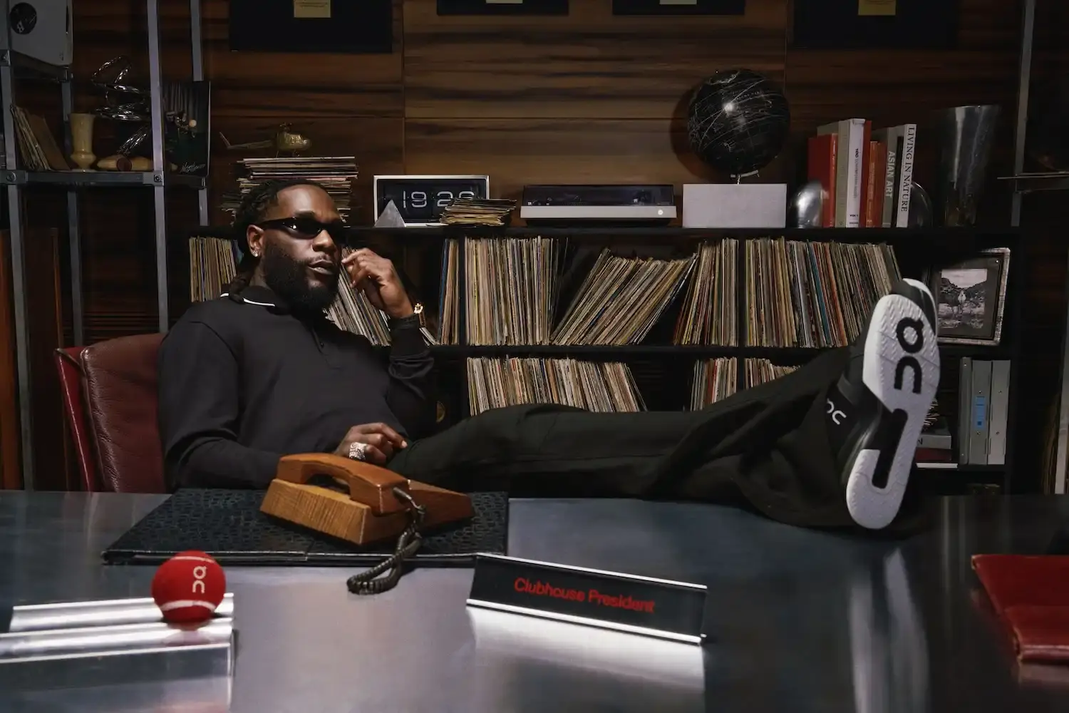 On athletic brand logo alongside Burna Boy promotional image