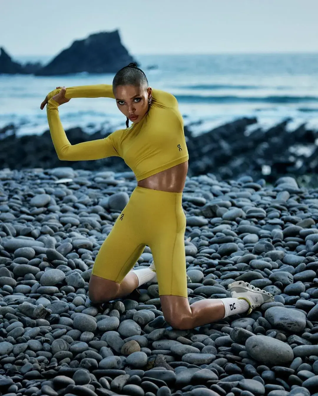 FKA twigs engaging in a holistic training session, highlighting the connection between mind and body. The image, part of On’s ‘The Body is Art’ campaign, evokes a sense of inner beauty and meditative well-being