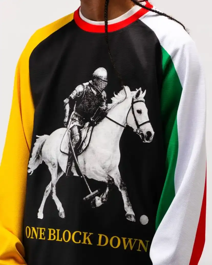 ONE BLOCK DOWN FW25 COLLECTION LAUNCHES IN MILAN Article about One Block Down's Fall/Winter 2025 collection, which combines medieval imagery, hockey aesthetics, and European winter sports culture in a streetwear context. (image 20 of 21)