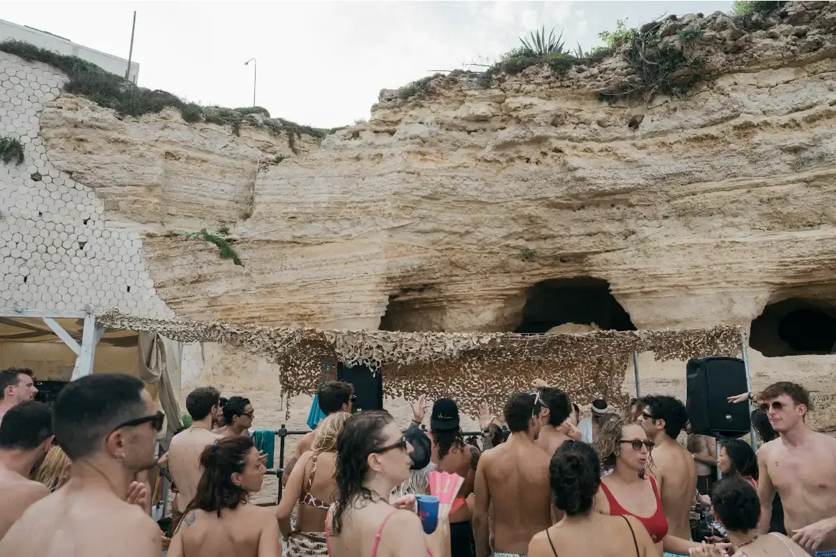 image about Ortigia Music Festival, a four-day electronic music event taking place on the island of Ortigia in Sicily from July 31 to August 3, 2025. The content describes the festival's venues including boat parties, beach stages, and late-night indoor spaces, along with performer lineup details and scheduling information. The article provides factual coverage of the event's programming, location context, and ticketing information for readers interested in electronic music festivals in the Mediterranean region.