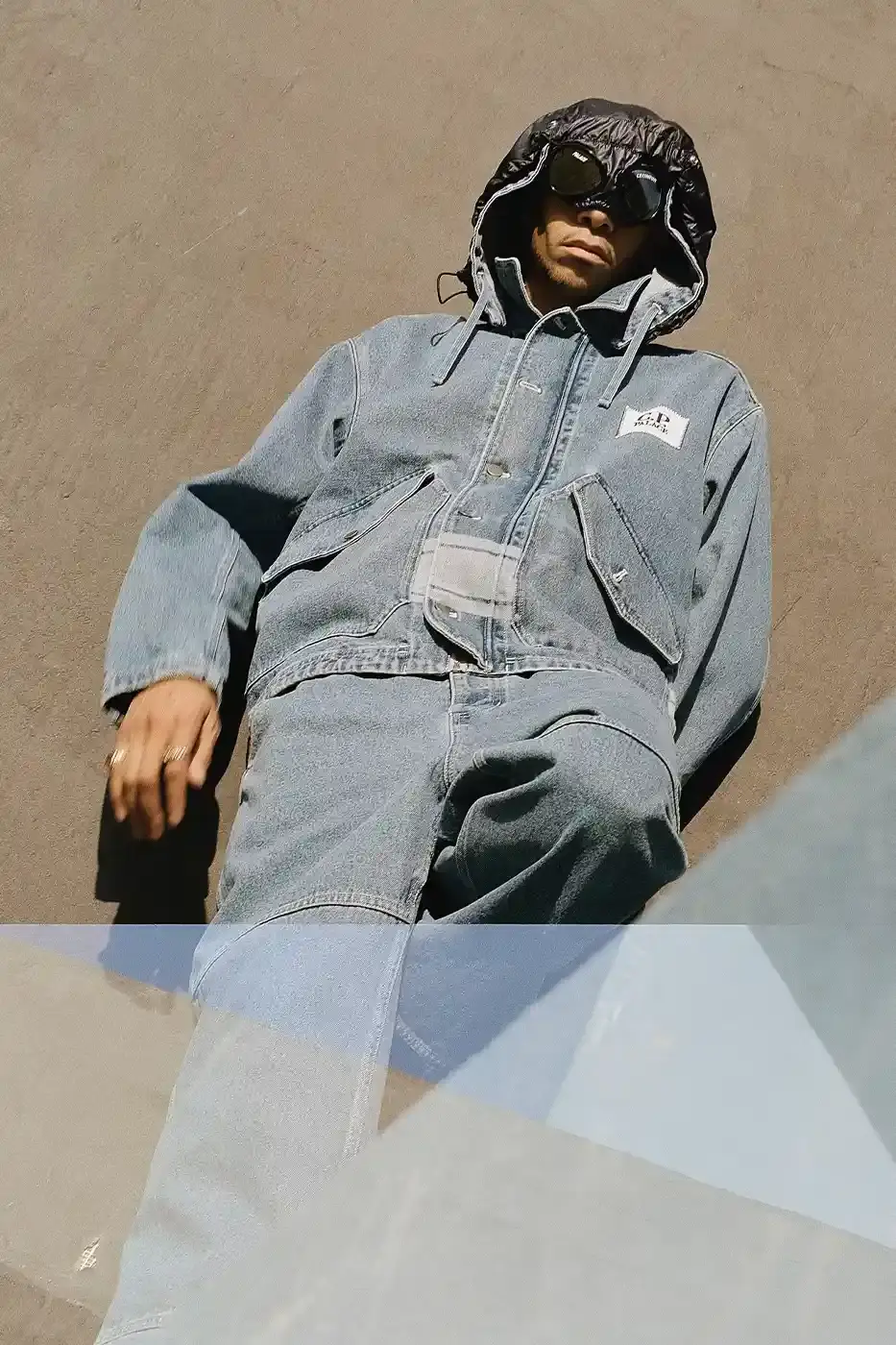 PALACE MEETS C.P. COMPANY: SKATE STYLE FUSES WITH ITALIAN CRAFT A fashion collaboration between Palace and C.P. Company. It details the "C.P. Palace" capsule collection featuring the Goggle Jacket, denim pieces, and various apparel in blue and khaki colors. The article provides information about the collection's availability starting March 28 at C.P. Company and Palace stores in multiple cities, plus a special pop-up at Dover Street Market Paris from March 28-30. (image 16 of 21)