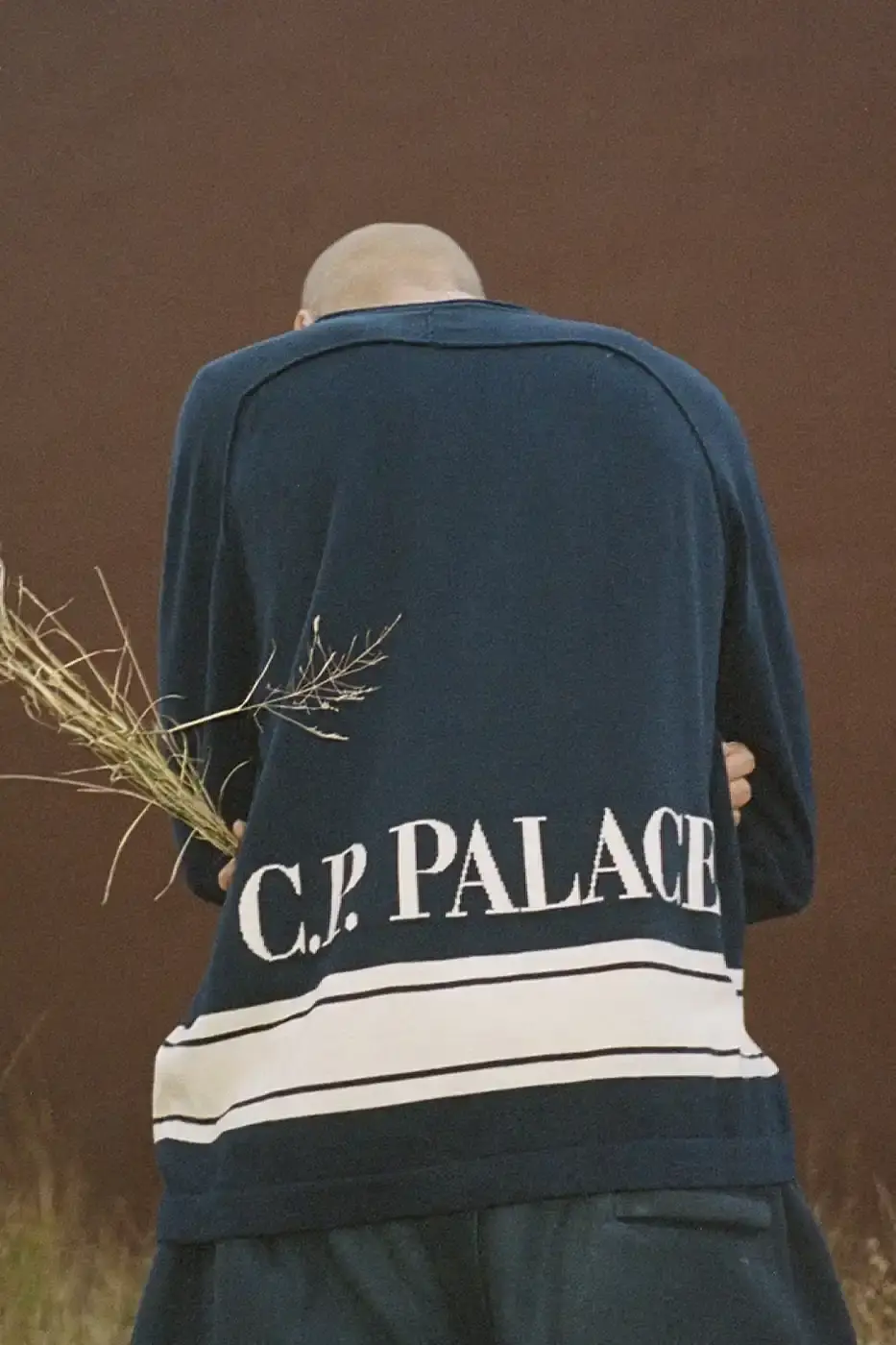PALACE MEETS C.P. COMPANY: SKATE STYLE FUSES WITH ITALIAN CRAFT A fashion collaboration between Palace and C.P. Company. It details the "C.P. Palace" capsule collection featuring the Goggle Jacket, denim pieces, and various apparel in blue and khaki colors. The article provides information about the collection's availability starting March 28 at C.P. Company and Palace stores in multiple cities, plus a special pop-up at Dover Street Market Paris from March 28-30. (image 5 of 21)