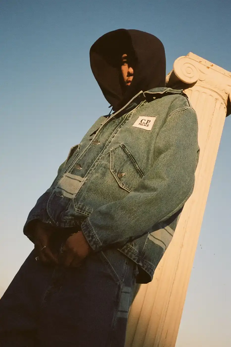 PALACE MEETS C.P. COMPANY: SKATE STYLE FUSES WITH ITALIAN CRAFT A fashion collaboration between Palace and C.P. Company. It details the "C.P. Palace" capsule collection featuring the Goggle Jacket, denim pieces, and various apparel in blue and khaki colors. The article provides information about the collection's availability starting March 28 at C.P. Company and Palace stores in multiple cities, plus a special pop-up at Dover Street Market Paris from March 28-30. (image 6 of 21)