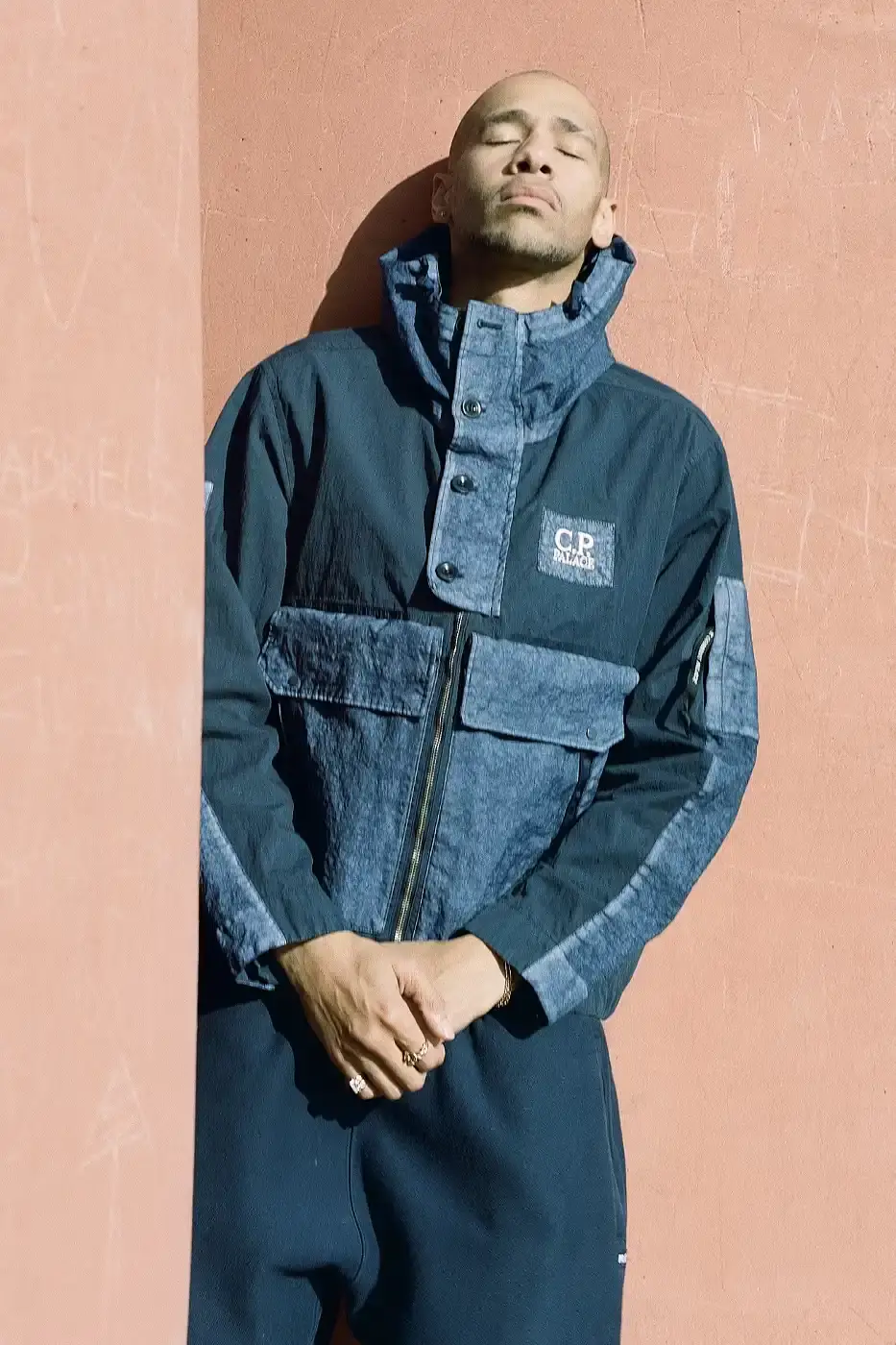 PALACE MEETS C.P. COMPANY: SKATE STYLE FUSES WITH ITALIAN CRAFT A fashion collaboration between Palace and C.P. Company. It details the "C.P. Palace" capsule collection featuring the Goggle Jacket, denim pieces, and various apparel in blue and khaki colors. The article provides information about the collection's availability starting March 28 at C.P. Company and Palace stores in multiple cities, plus a special pop-up at Dover Street Market Paris from March 28-30. (image 12 of 21)