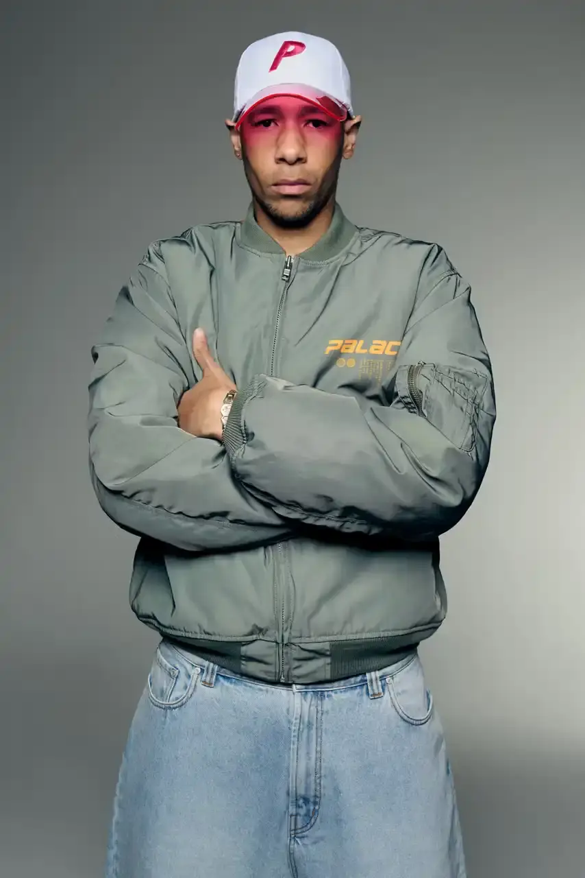 PALACE SUMMER 2025 COLLECTION: LONDON LABEL REVEALS SEASONAL LINEUP image of Palace's Summer 2025 collection announcement, describing the London streetwear brand's new seasonal offerings. It details the collection's design influences (Americana, sportswear, military), highlights key pieces including Los Angeles-themed items, religious iconography adaptations, and mesh garments for warm weather. The text also provides specific release dates and times for different global regions including the UK, Europe, US, Japan, Seoul, and China, with information about both online and physical store availability. (image 34 of 36)