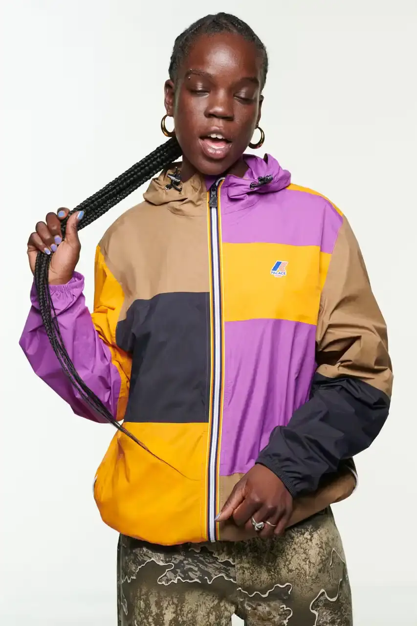 Palace Skateboards/Theo Sion Palace Spring 2025 lookbook showcasing a diverse collection of streetwear. Various models wear pieces including a tiger-embroidered varsity jacket, GORE-TEX outerwear, camouflage patterns, and racing-inspired jerseys. The collection features a mix of athletic and casual styles in multiple colorways, with detailed shots of snake graphics and workwear pieces (image 4 of 20)