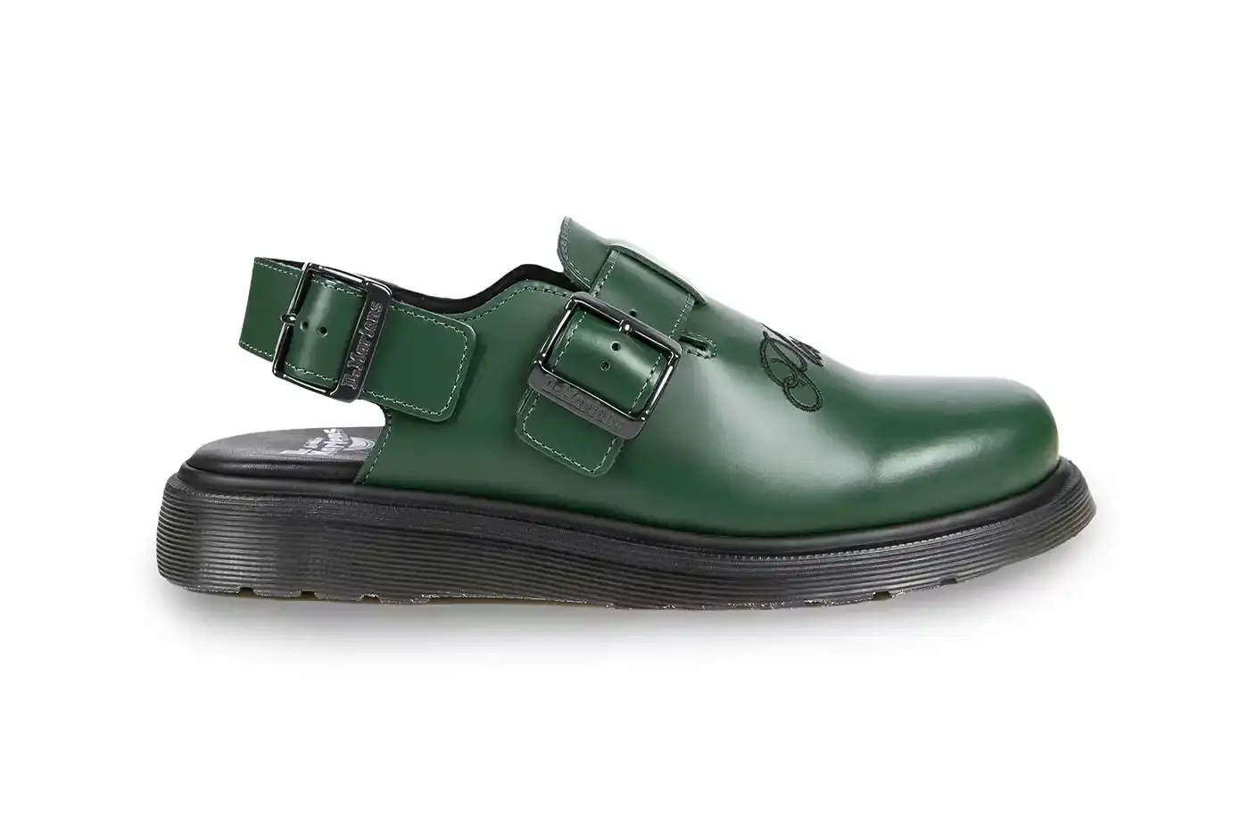 Ian Dooley/Pleasures Green leather Dr. Martens Jorge Mule featuring black metal buckles, cursive PLEASURES branding stitched on the upper, signature yellow stitching, and a black Vibram outsole. The collaboration merges both brands' distinctive styles in a versatile slip-on design. (image 3 of 11)