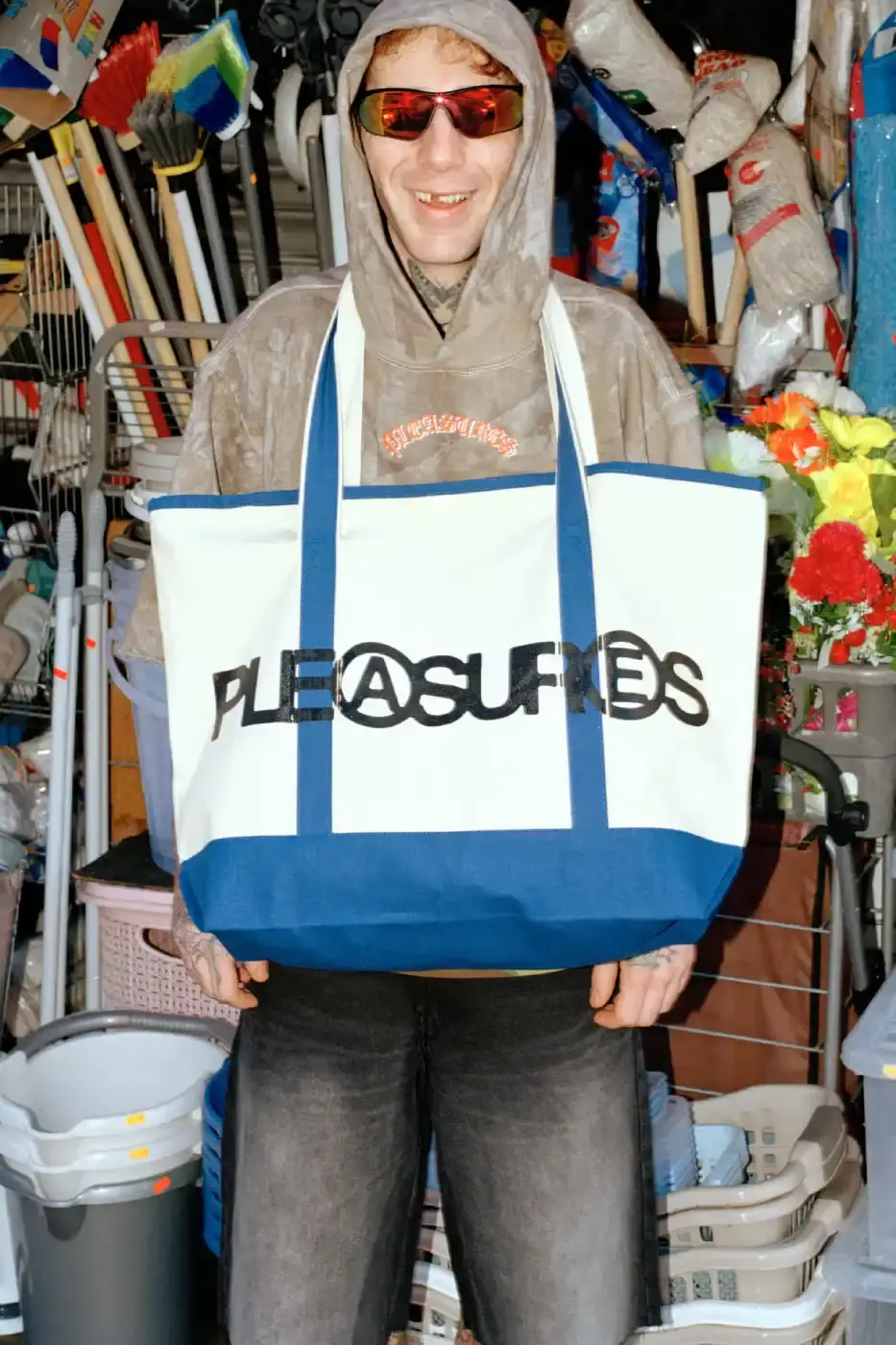 PLEASURES STRANGE WAYS EVERYDAY SPRING 2026 An article detailing the PLEASURES Spring 2026 clothing collection featuring workwear, denim, and graphic shirts shot by Jason Landis in London. (image 14 of 40)
