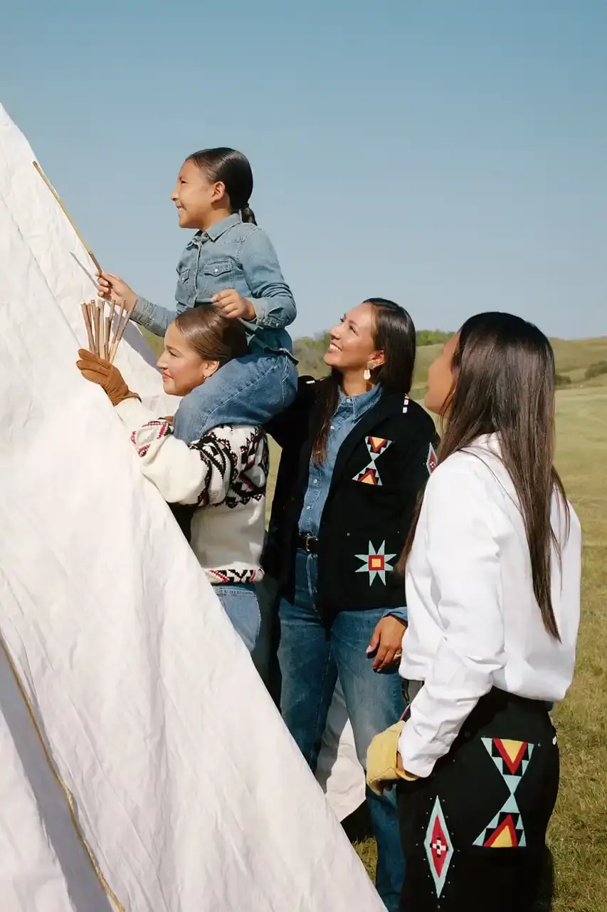 POLO RALPH LAUREN PARTNERS WITH TÓPA Polo Ralph Lauren and TÓPA, an Indigenous-led fashion label, release a collection combining traditional Northern Plains designs with modern apparel. The partnership supports Indigenous language preservation through Thunder Valley CDC. (image 5 of 14)