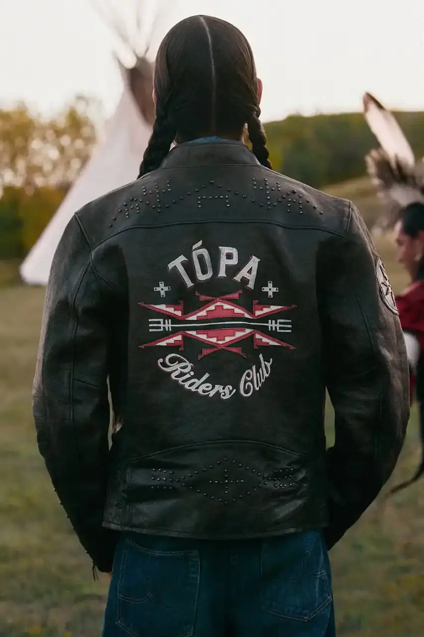 POLO RALPH LAUREN PARTNERS WITH TÓPA Polo Ralph Lauren and TÓPA, an Indigenous-led fashion label, release a collection combining traditional Northern Plains designs with modern apparel. The partnership supports Indigenous language preservation through Thunder Valley CDC. (image 2 of 14)