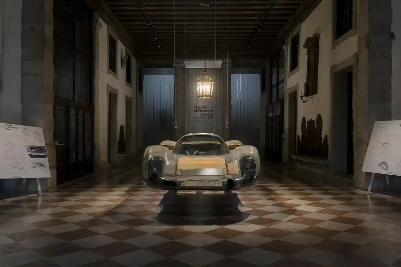 FOSTER AND PORSCHE PRESENT VENICE TRANSPORT HUB image about architectural partnership between Porsche and Norman Foster Foundation presenting electric mobility concepts at Venice Biennale. Content includes details about a 120-foot installation featuring sustainable transportation solutions like electric boats and water bikes, exhibition locations, and future collaboration plans. Text is structured with clear headings, bullet point summary, and descriptive paragraphs suitable for screen readers. (image 7 of 8)