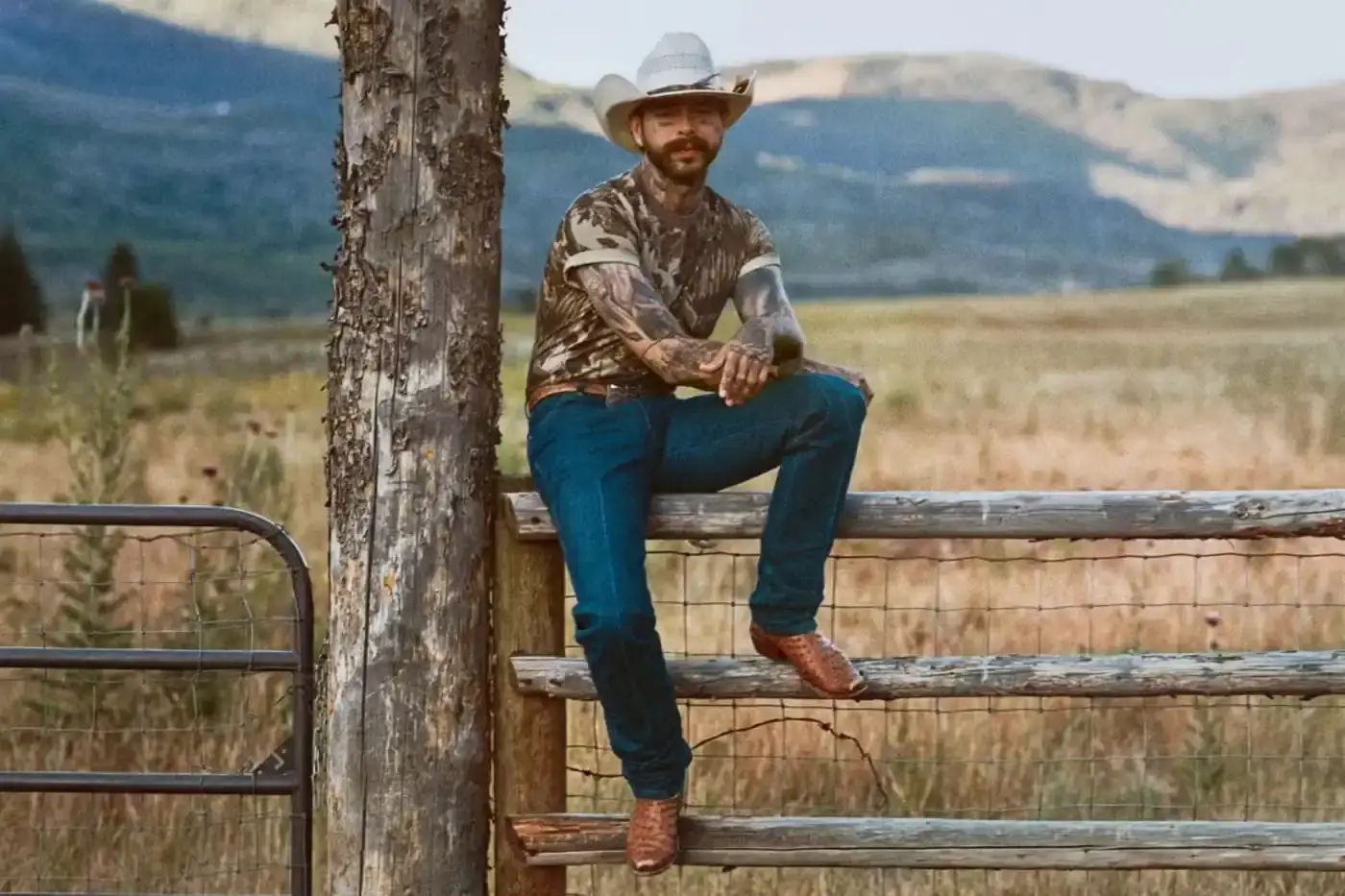 POST MALONE MODELS SKIMS MENS CAMO COLLECTION Post Malone photographed wearing SKIMS menswear including camouflage patterns and fleece clothing for brand campaign. (image 3 of 3)