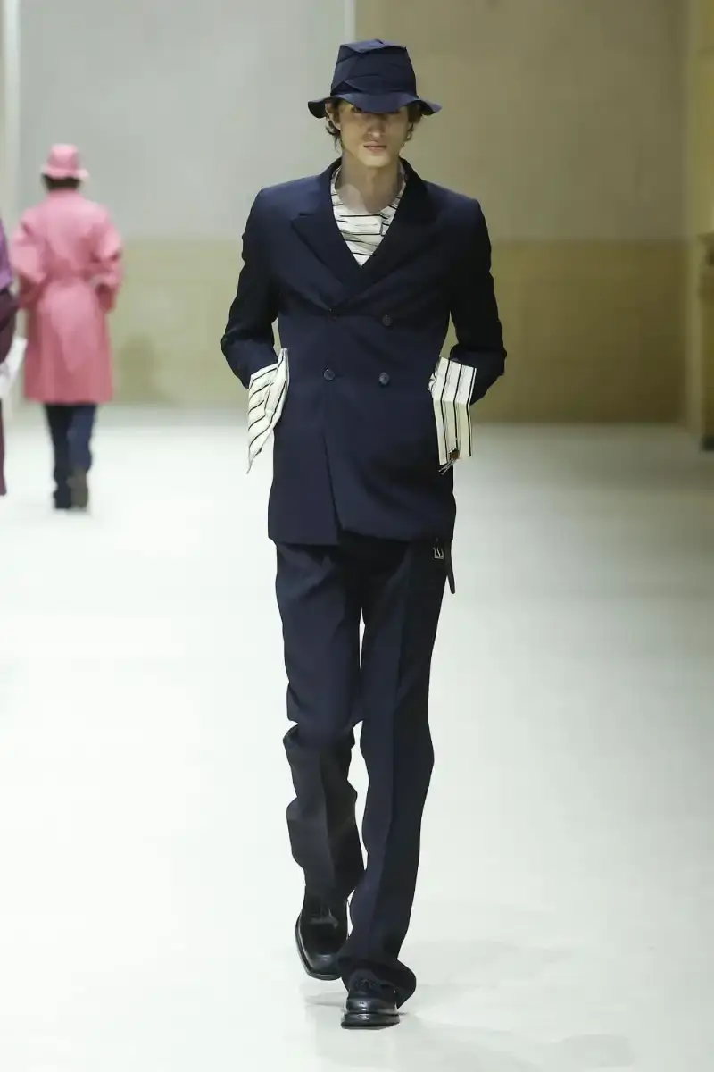 PRADA FALL/WINTER 2026 MENSWEAR REVIEW Analysis of Prada's Fall/Winter 2026 menswear collection presented in Milan, featuring structured tailoring, pastel color palette, and classical architectural influences. (image 2 of 26)