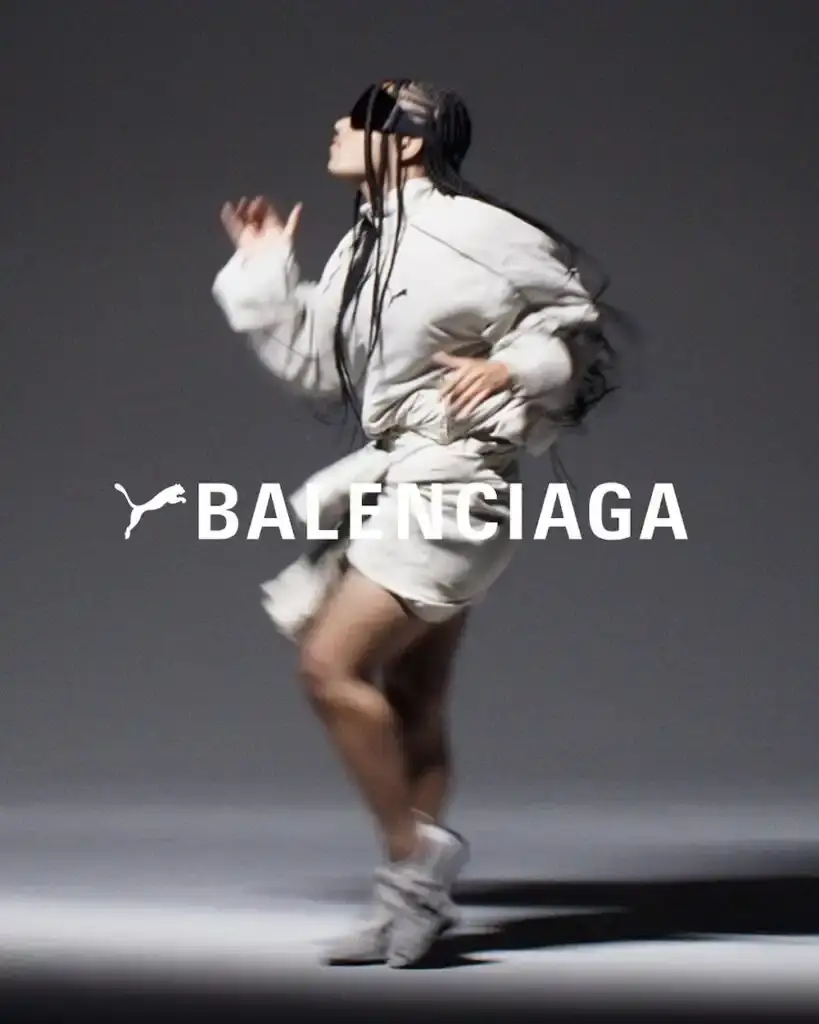 PUMA X BALENCIAGA COLLECTION LAUNCHES image about the retail launch of PUMA and Balenciaga's collaborative Winter 2025 collection, including details about sneaker variations, apparel offerings, and campaign photography. The collection merges athletic and luxury fashion elements across footwear and clothing items. (image 2 of 5)