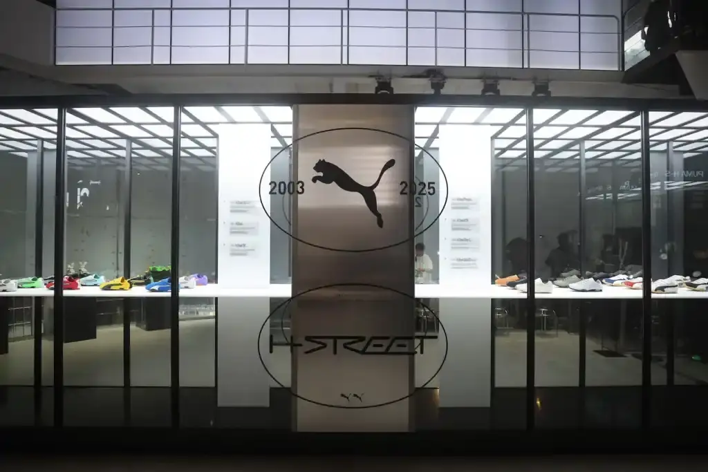PUMA'S H-STREET SNEAKERS LAUNCH CELEBRATED WITH SEOUL EXHIBITION image of PUMA's H-Street sneakers launch event in Seoul, describing the exhibition venue's athletics-inspired design, notable attendees including K-pop celebrity Rosé, and quotes from PUMA's Global Marketing Director. The piece explains that the exhibition is part of PUMA's Future Archives initiative honoring classic designs and mentions that it remains open to the public through May 18 with various interactive elements including styling areas, music spaces, archival displays, and group activities. (image 4 of 8)