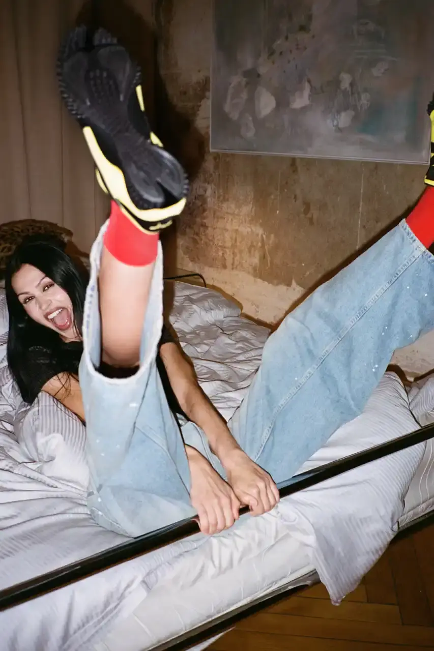 PUMA MOSTRO RETURNS IN PELÉ YELLOW WITH AMELIA GRAY image of PUMA's latest Mostro sneaker release in yellow colorway, featuring model Amelia Gray in promotional campaign imagery. Includes product specifications, pricing at $120 USD, and June 5 release date through PUMA retail channels. (image 3 of 7)