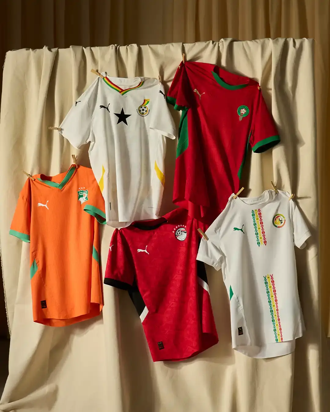Puma Morocco's white away jersey displaying traditional rug-inspired protective symbols, with contrasting trim details