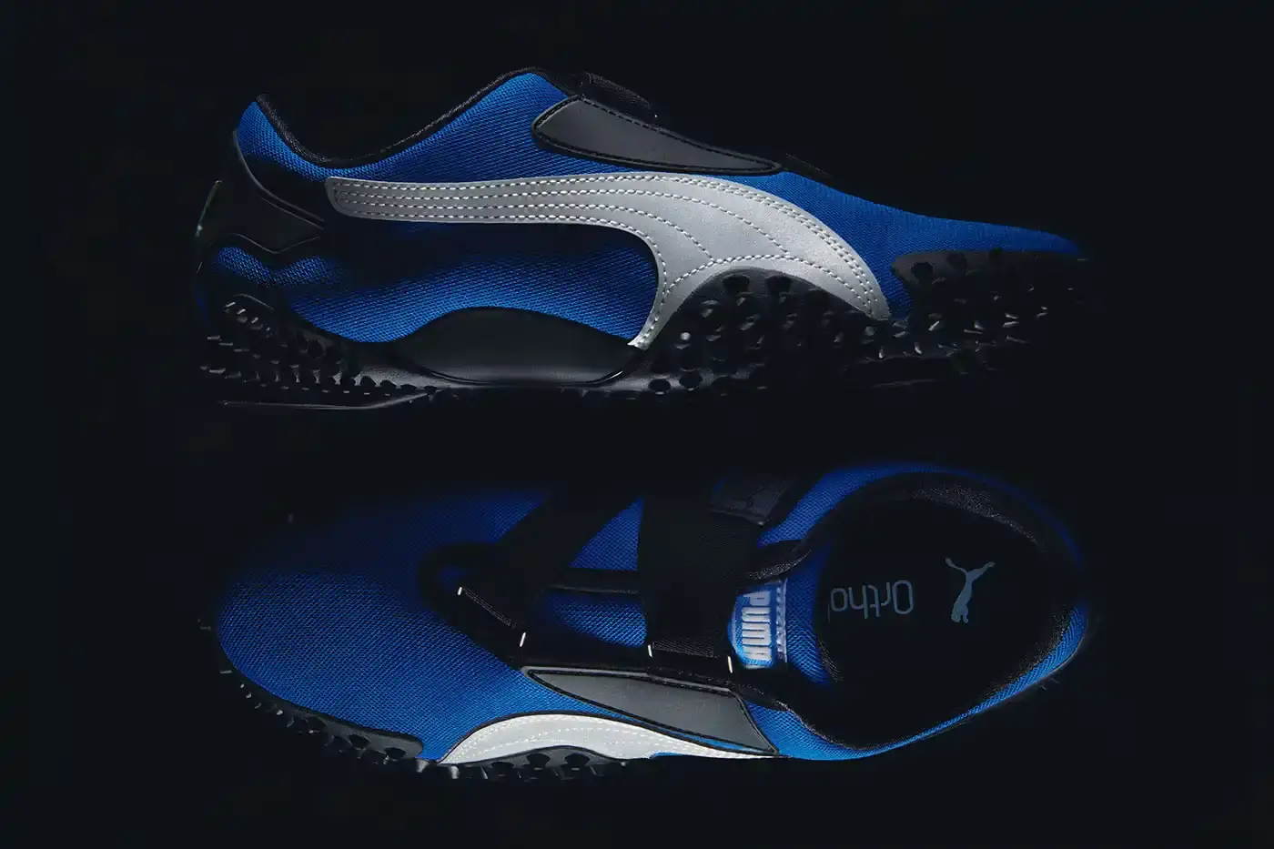 Puma PUMA Mostro OG sneakers displayed in three colorways - Team Royal blue with silver accents, Green Moon green with silver detailing, and All Time Red with silver trim. Each shoe features the model's distinctive spiked sole, mesh upper, and hook-and-loop fastening system. (image 2 of 8)