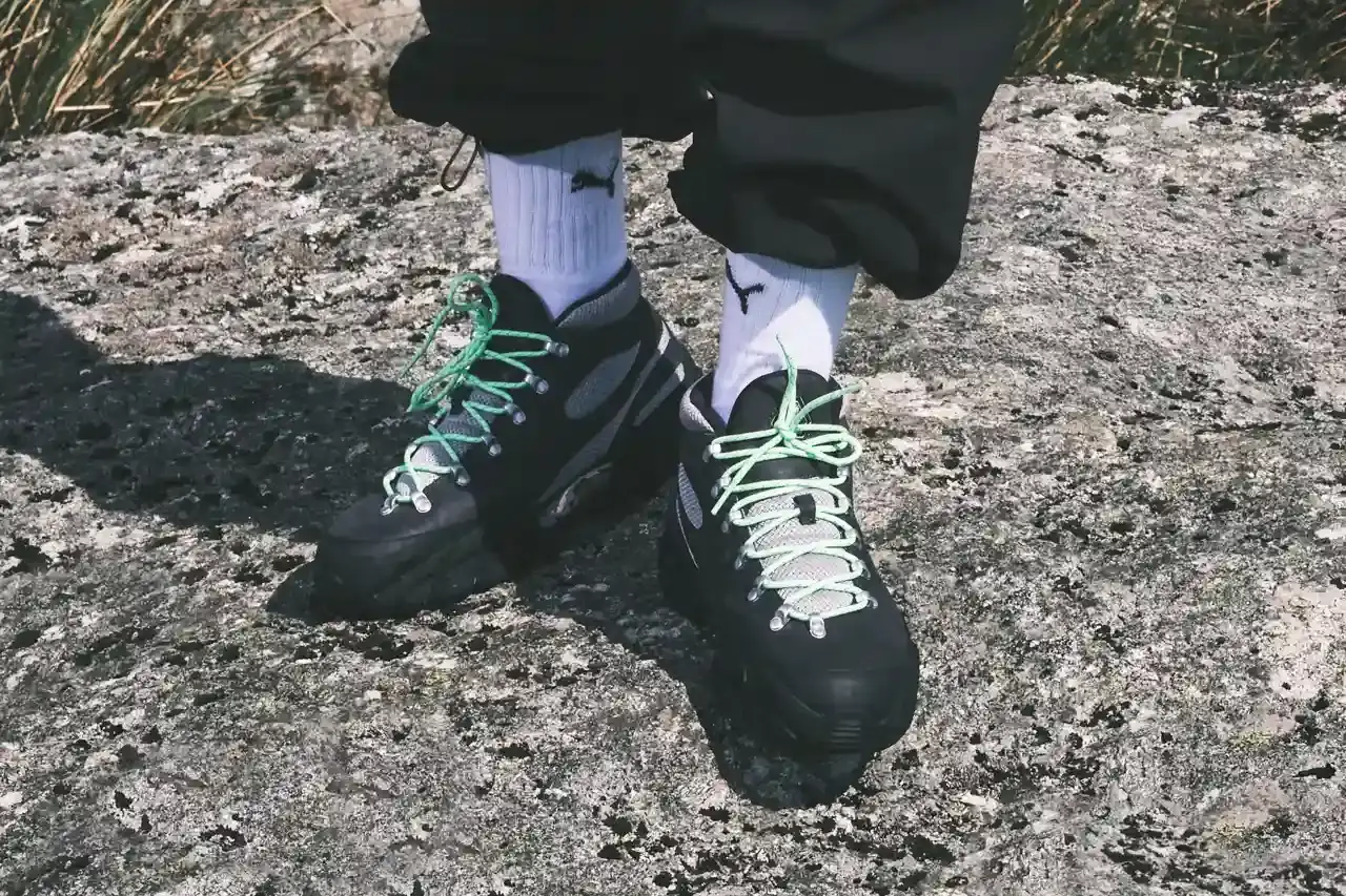Puma PUMA x Skepta Skope Forever Mid sneaker in Flat Dark Gray/PUMA Silver/PUMA Black colorway, featuring black leather uppers, gray mesh panels, chrome accents, and bright turquoise laces. The shoe has a distinctive Y2K-inspired silhouette with utilitarian details. (image 2 of 10)