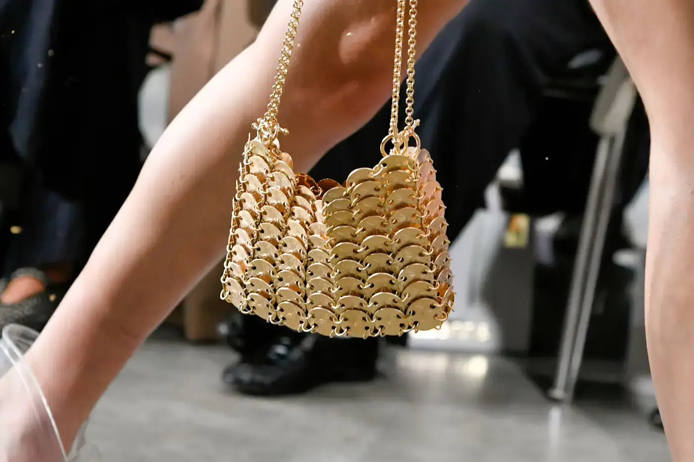 Rabanne unveils 18-karat gold handbag at Paris Fashion Week Spring/Summer 2025, claiming it to be the world's most expensive bag. Inspired by Paco Rabanne's 1968 gold and diamond dress for Françoise Hardy, the 1969 Nano bag is priced at €250,000. The runway show also featured innovative glass and ceramic bags, showcasing Rabanne's heritage of using unconventional materials in luxury fashion design. Creative Director Julien Dossena continues the brand's tradition of blending artistry with high-end craftsmanship, as seen in collaborations with Arthus Bertrand, Venini, and Astier de Villatte