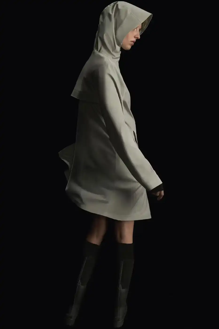 Rains RAINS Spring/Summer 2025 collection featuring models wearing the new Suva Hardshell jackets and pants in an urban setting, showcasing the matte finish and minimalist design of the waterproof apparel. (image 8 of 10)