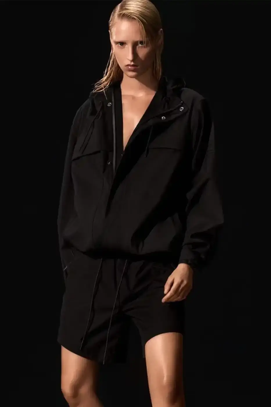 Rains RAINS Spring/Summer 2025 collection featuring models wearing the new Suva Hardshell jackets and pants in an urban setting, showcasing the matte finish and minimalist design of the waterproof apparel. (image 4 of 10)