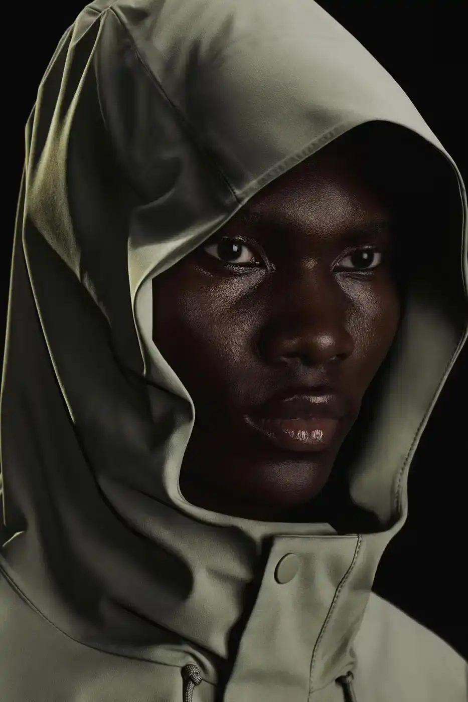 Rains RAINS Spring/Summer 2025 collection featuring models wearing the new Suva Hardshell jackets and pants in an urban setting, showcasing the matte finish and minimalist design of the waterproof apparel. (image 3 of 10)