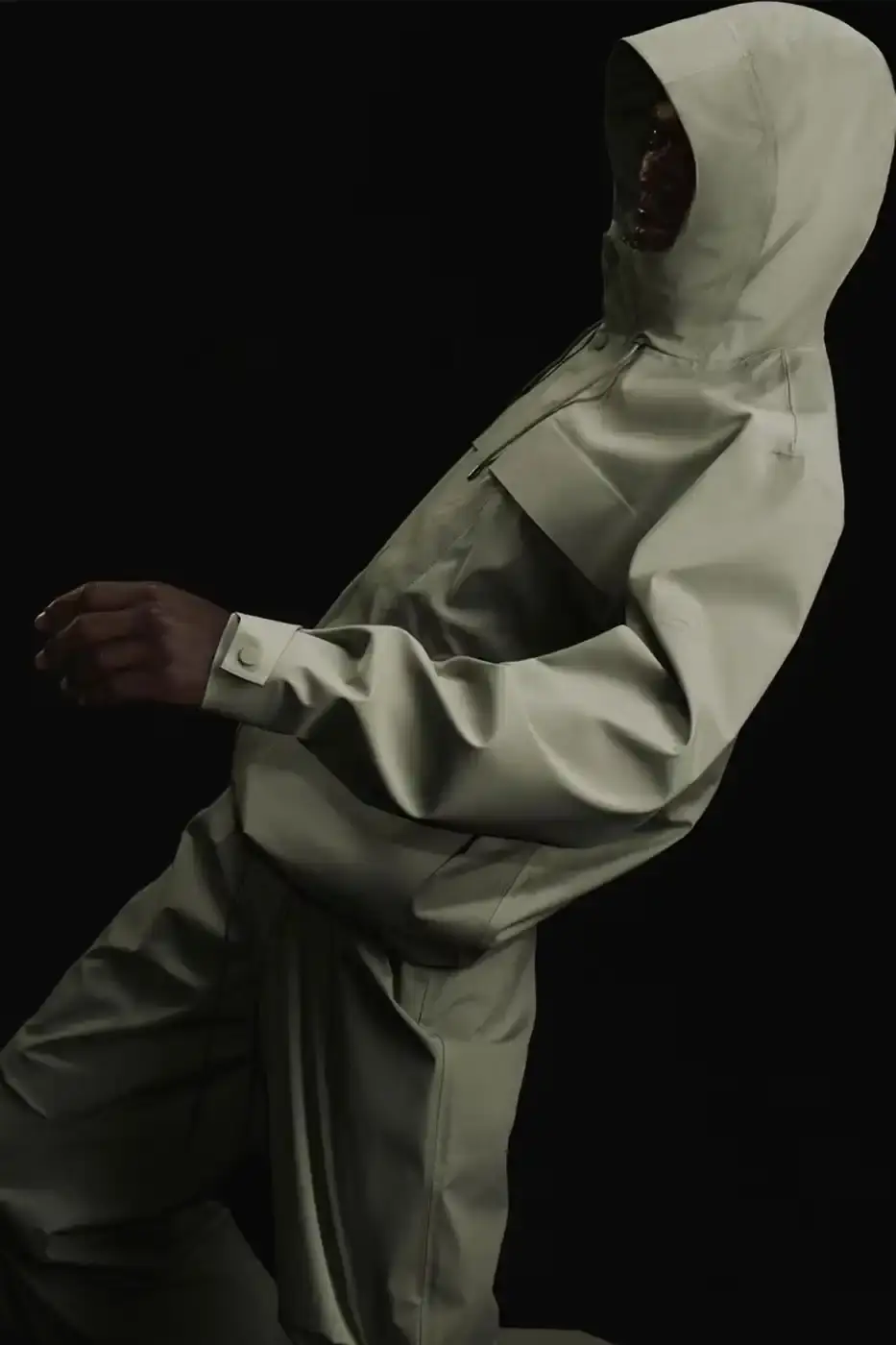 Rains RAINS Spring/Summer 2025 collection featuring models wearing the new Suva Hardshell jackets and pants in an urban setting, showcasing the matte finish and minimalist design of the waterproof apparel. (image 2 of 10)