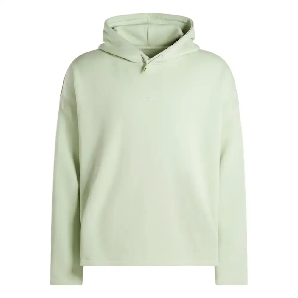 Reebok Tobe Nwigwe wearing a mint green coach jacket and black pants from the Reebok x Chukwu collection, standing next to the Chukwu OTU sneaker (image 6 of 9)