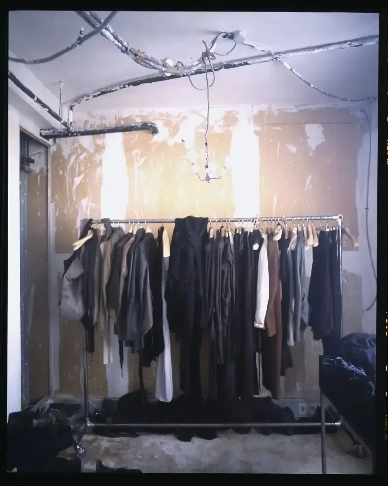 Interior of Rick Owens' Parisian home featuring unpolished concrete floors and distinctive furniture including the "Pedalo chair" with a resin base and cashmere covering.