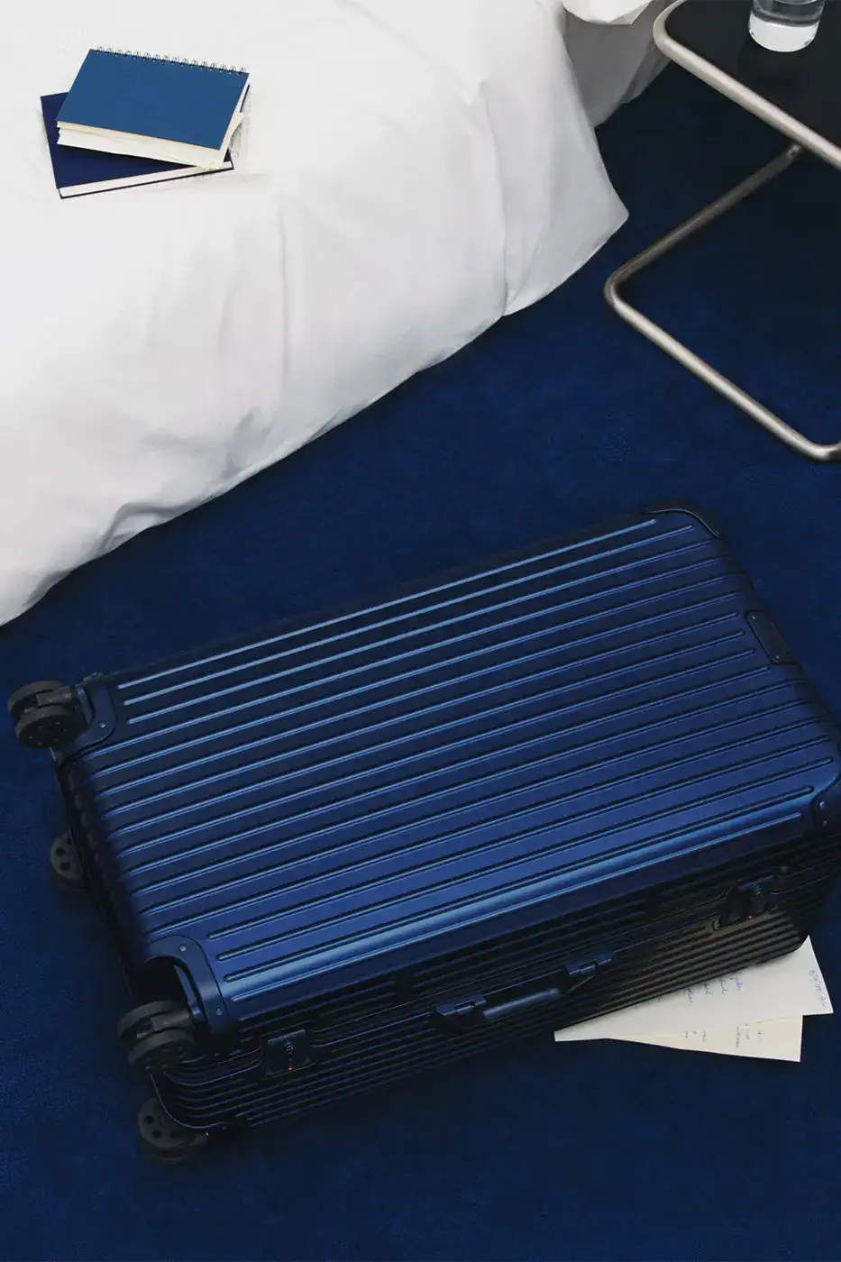 RIMOWA ORIGINAL LUGGAGE GAINS PERMANENT INK BLUE SHADE image announces the release of RIMOWA's permanent Ink Blue colorway for Original aluminium suitcases, detailing dimensions, pricing, and matching accessories. (image 7 of 9)