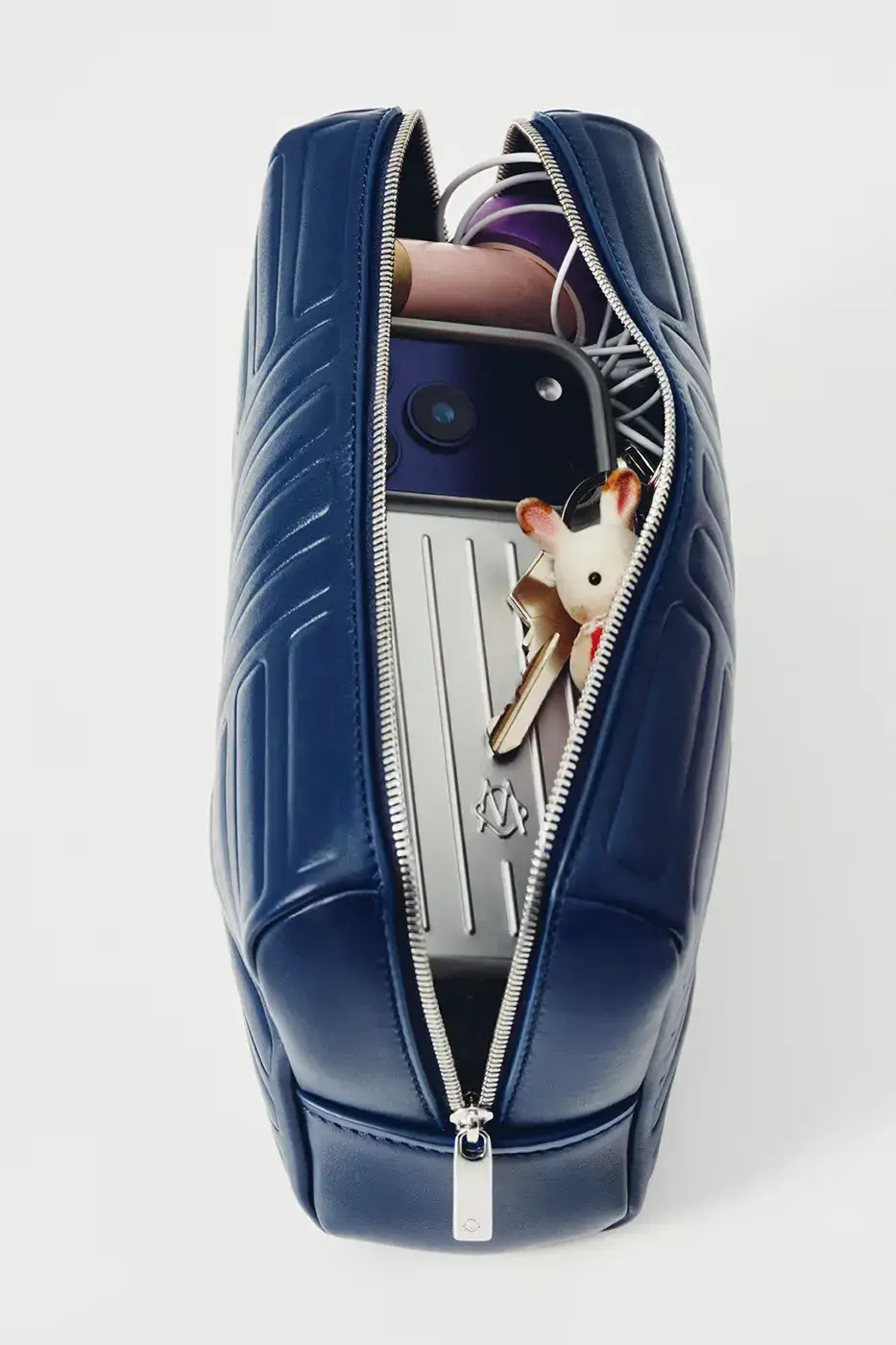 RIMOWA ORIGINAL LUGGAGE GAINS PERMANENT INK BLUE SHADE image announces the release of RIMOWA's permanent Ink Blue colorway for Original aluminium suitcases, detailing dimensions, pricing, and matching accessories. (image 5 of 9)