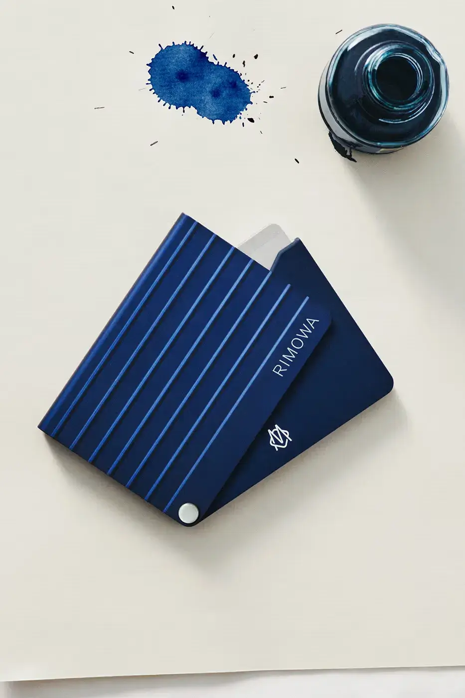 RIMOWA ORIGINAL LUGGAGE GAINS PERMANENT INK BLUE SHADE image announces the release of RIMOWA's permanent Ink Blue colorway for Original aluminium suitcases, detailing dimensions, pricing, and matching accessories. (image 2 of 9)