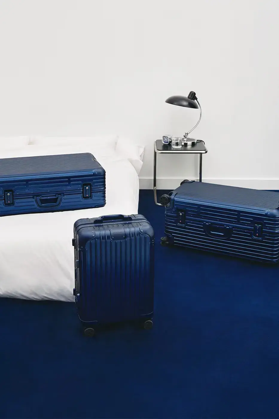 RIMOWA ORIGINAL LUGGAGE GAINS PERMANENT INK BLUE SHADE image announces the release of RIMOWA's permanent Ink Blue colorway for Original aluminium suitcases, detailing dimensions, pricing, and matching accessories.