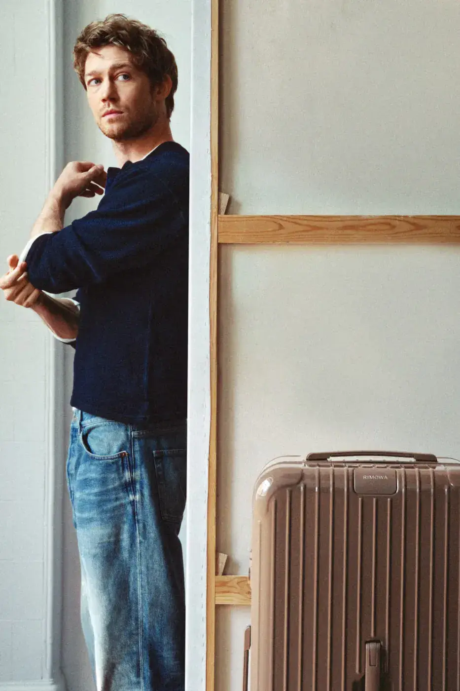 RIMOWA ADDS UMBER AND ULTRAMARINE TO ESSENTIAL AND GROOVE image about two new RIMOWA colors, Umber brown and Ultramarine blue, applied to Essential suitcases and Groove leather bags. Actor Joe Alwyn plays a young painter in the campaign. (image 3 of 10)
