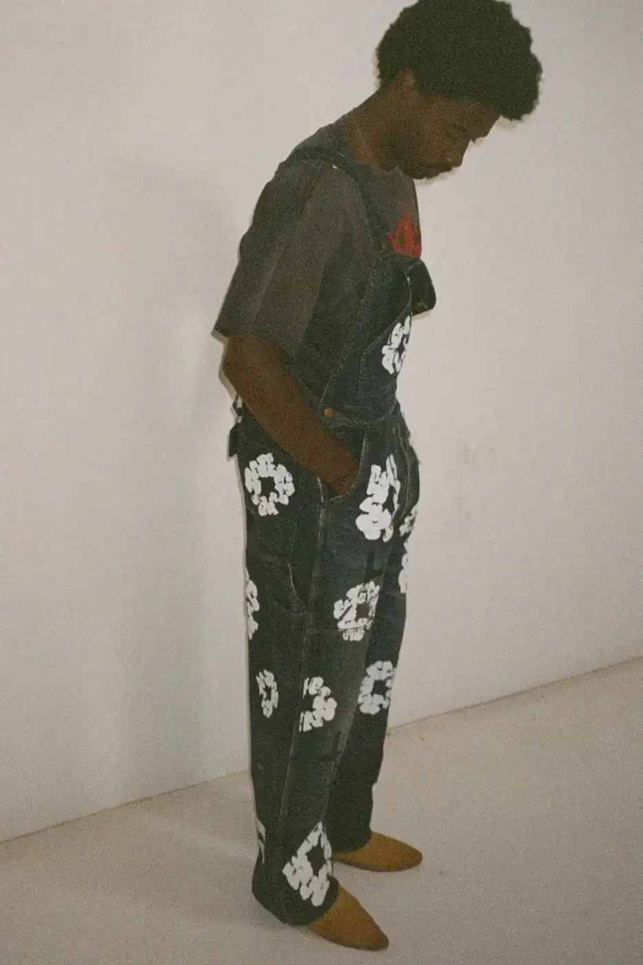 SAINT Mxxxxxx SAINT Mxxxxxx and Denim Tears collaborative Fall/Winter 2024 collection, displaying a tailored double-breasted blazer with wreath print, matching slacks, and a necktie (image 3 of 10)