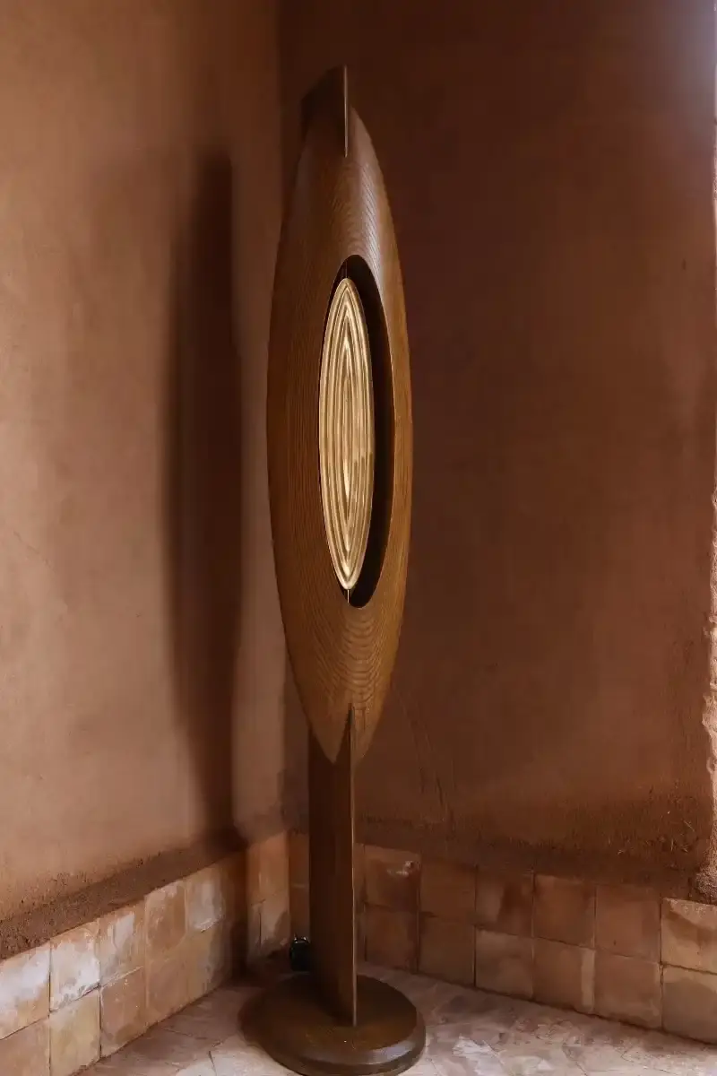 SALU IWADI GELEDE LAMP COLLECTION An image describing the Gelede lamp collection by Salu Iwadi Studio. The text details the materials and cultural meaning behind three lamp models. (image 6 of 11)