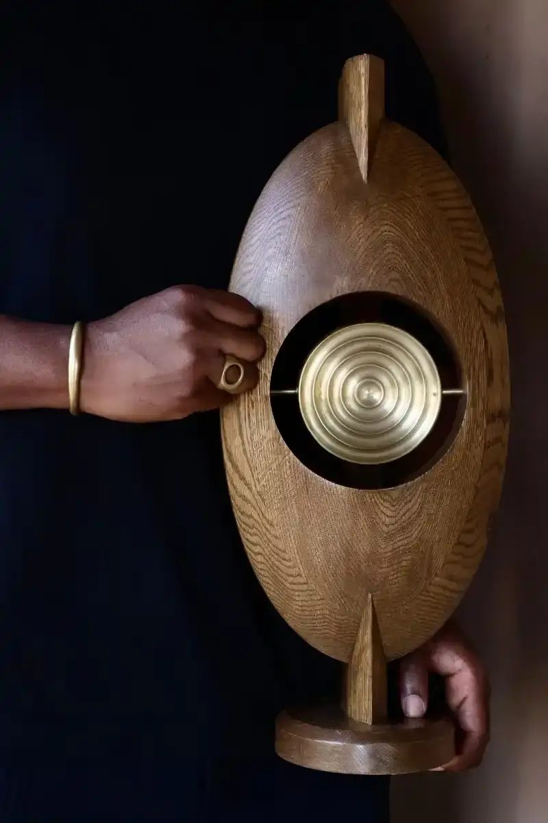 SALU IWADI GELEDE LAMP COLLECTION An image describing the Gelede lamp collection by Salu Iwadi Studio. The text details the materials and cultural meaning behind three lamp models. (image 11 of 11)